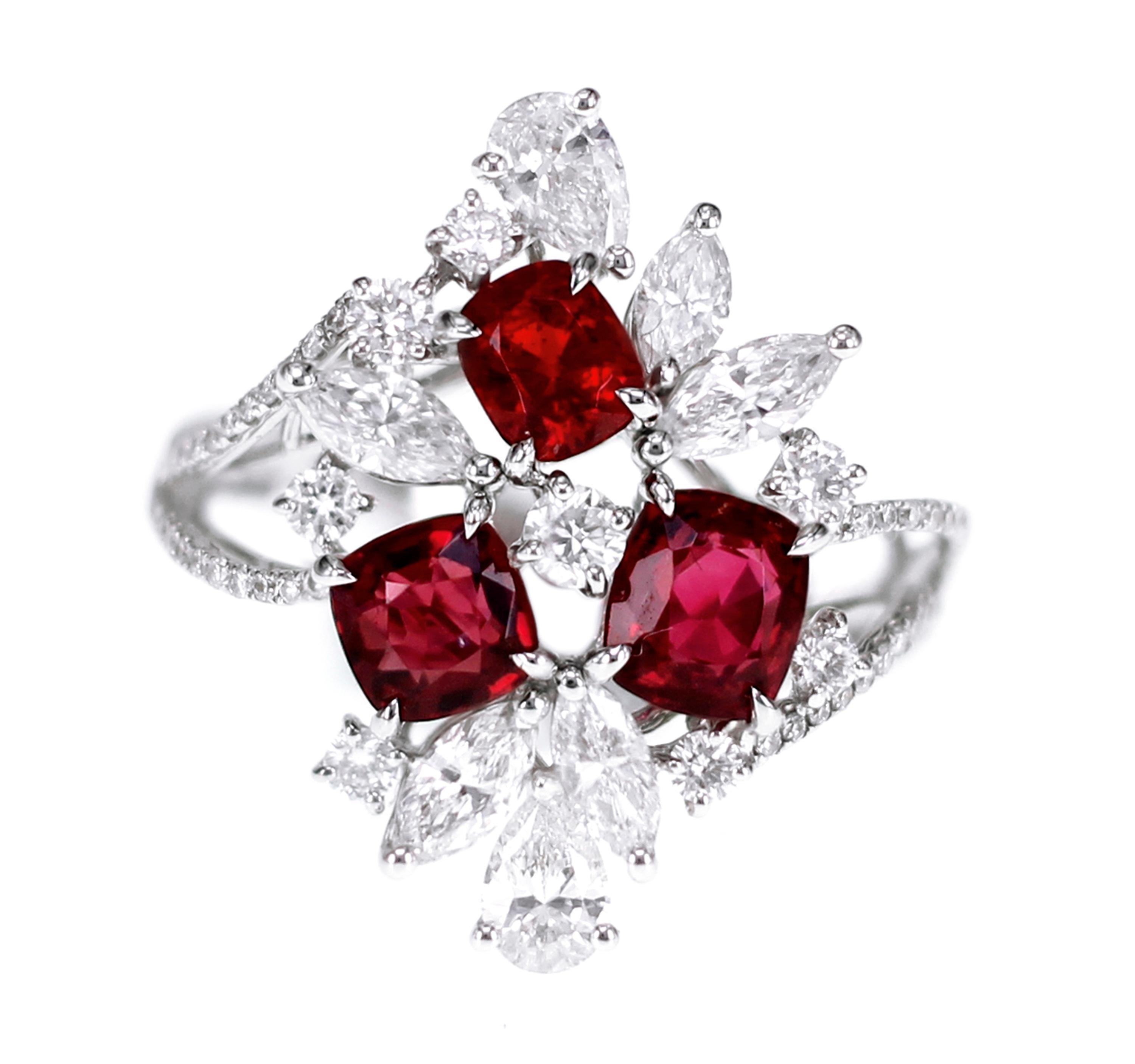 Three stones weighing 1.89 carat are set in a cocktail ring. The ring also consists of 1.34 carat of white brilliant diamond. The Burmese spinel has a vivid red hue and only a few stones carry this lovely color switch,