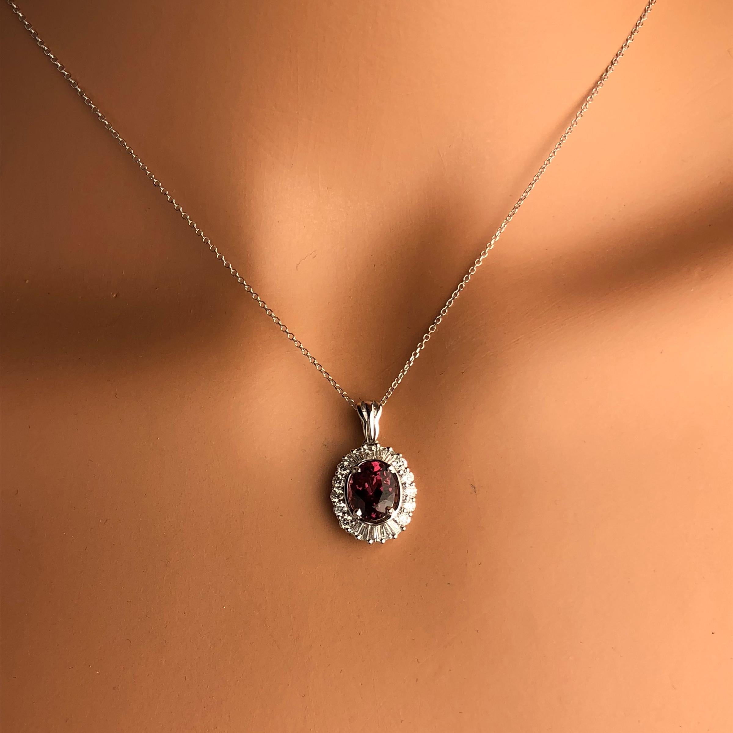 (DiamondTown) This lovely pendant features a 1.89 Carat Oval Cut exotic Raspberry Garnet center, surrounded by a halo of white diamonds. The total diamond weight is 0.58 carats.

Many of our items have matching companion pieces. Please