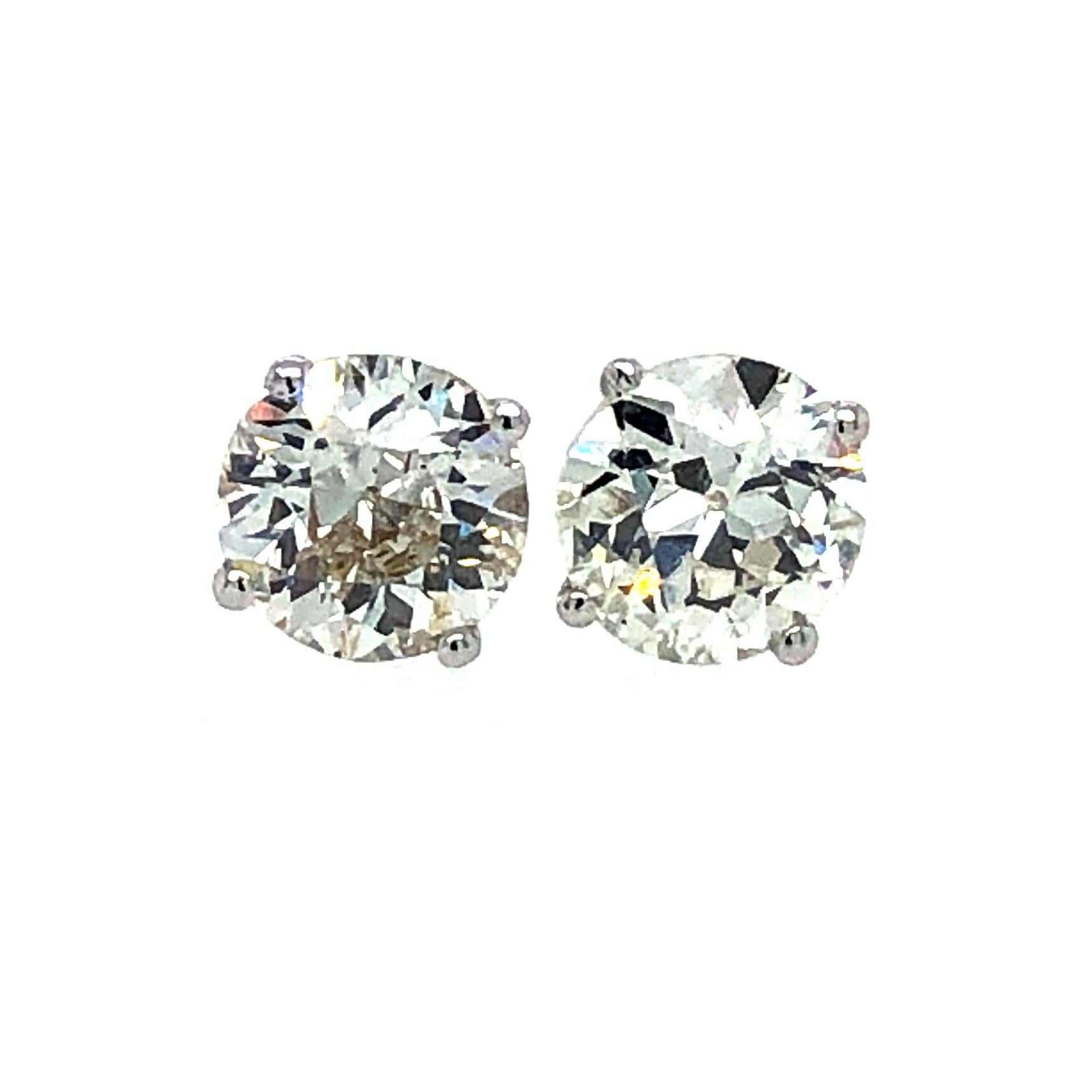 Offered here is a perfectly matched old European cut diamonds set in three ( 3 ) prong platinum martini settings. The diamonds are I-J color Vs2 to fine Si1 clarity with a total weight of about 1.89 carats. The studs are marked PT950 on the large