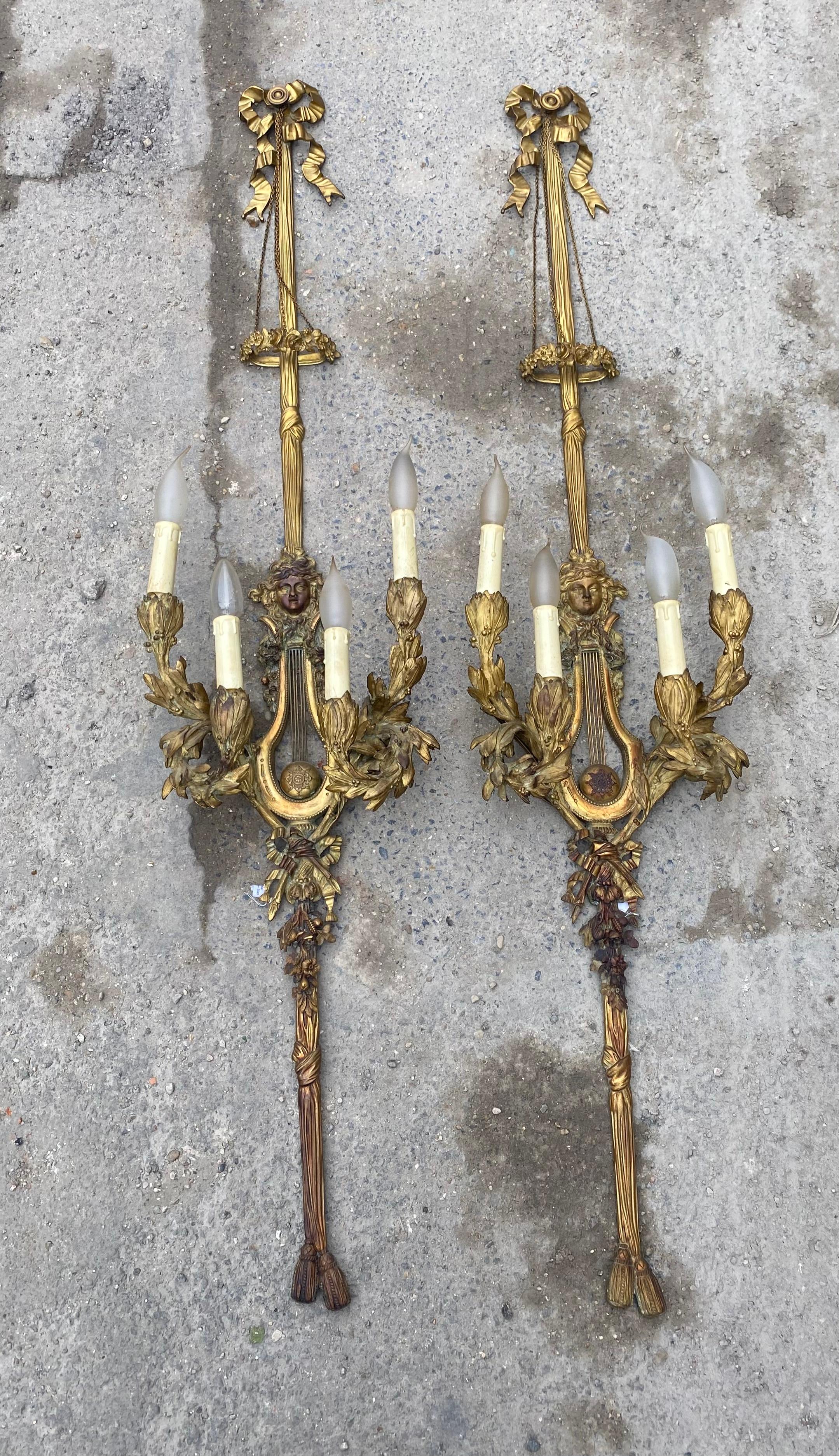 Paire d'appliques Louis 16 et 4 bras en bronze doré
conditions d'utilisation et oxydations
Ampoules à flamme E14
144 X 32 X 20,5 cm
Pierre Gouthière (1732-1813), fils d'un sellier, est devenu le plus célèbre bronzier et doreur parisien de la fin des
