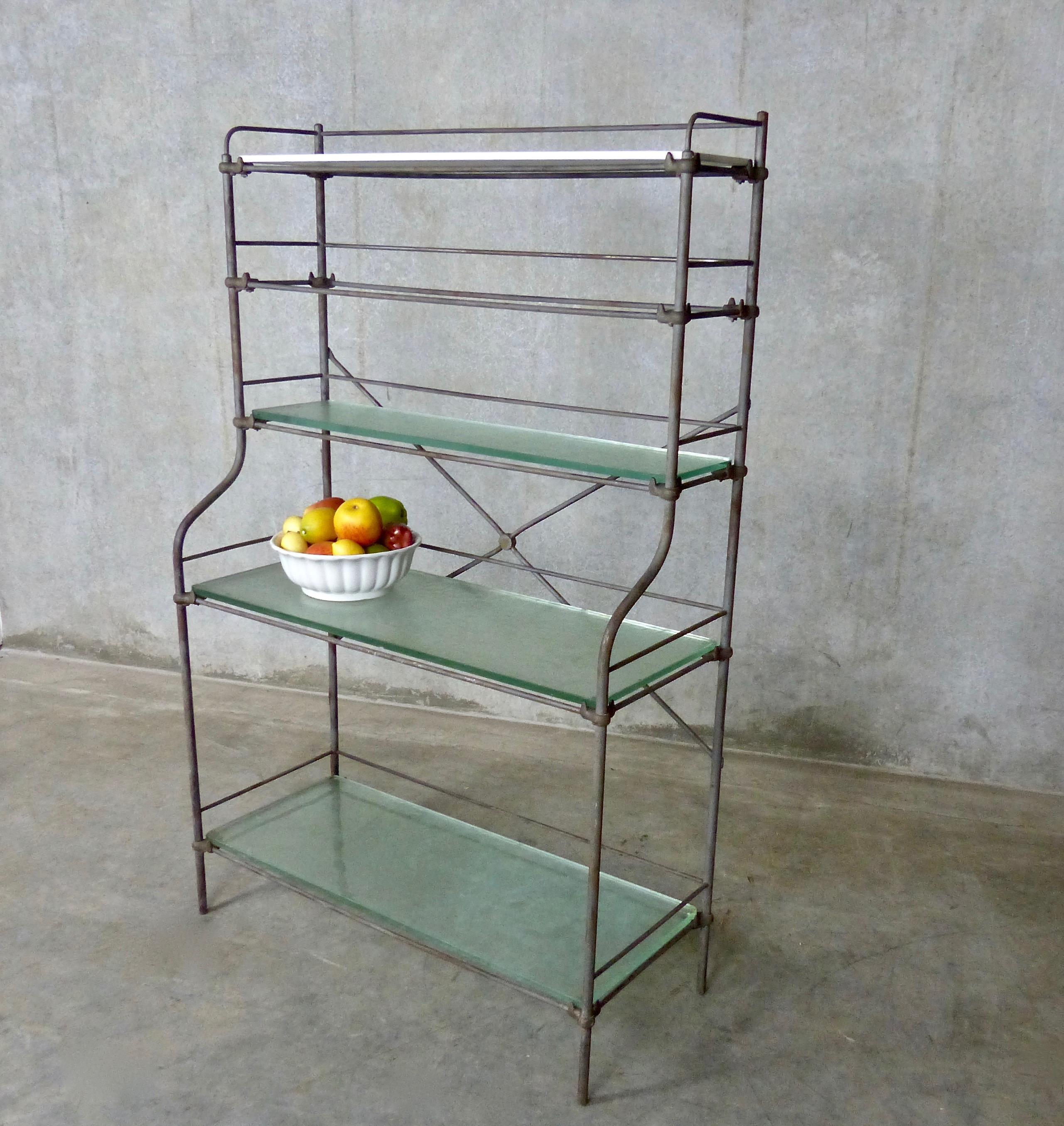 From the turn-of-the-last century, a five-tier, iron shelving unit/étagère from France. Features include glass shelves, unusual corner joinery, and stepped out lower shelves. Great storage/display unit for indoors or outdoors.
Dimensions: 59 H” x