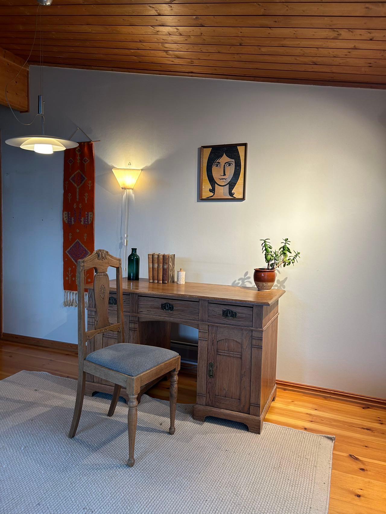 Primitive antique writing desk/office table, handcrafted in Norway / Denmark between 1890-1910, is designed in the late Art Nouveau style. 

Made from natural oak, it features 3 drawers, 2 cabinets, and includes the original key and lock. The desk