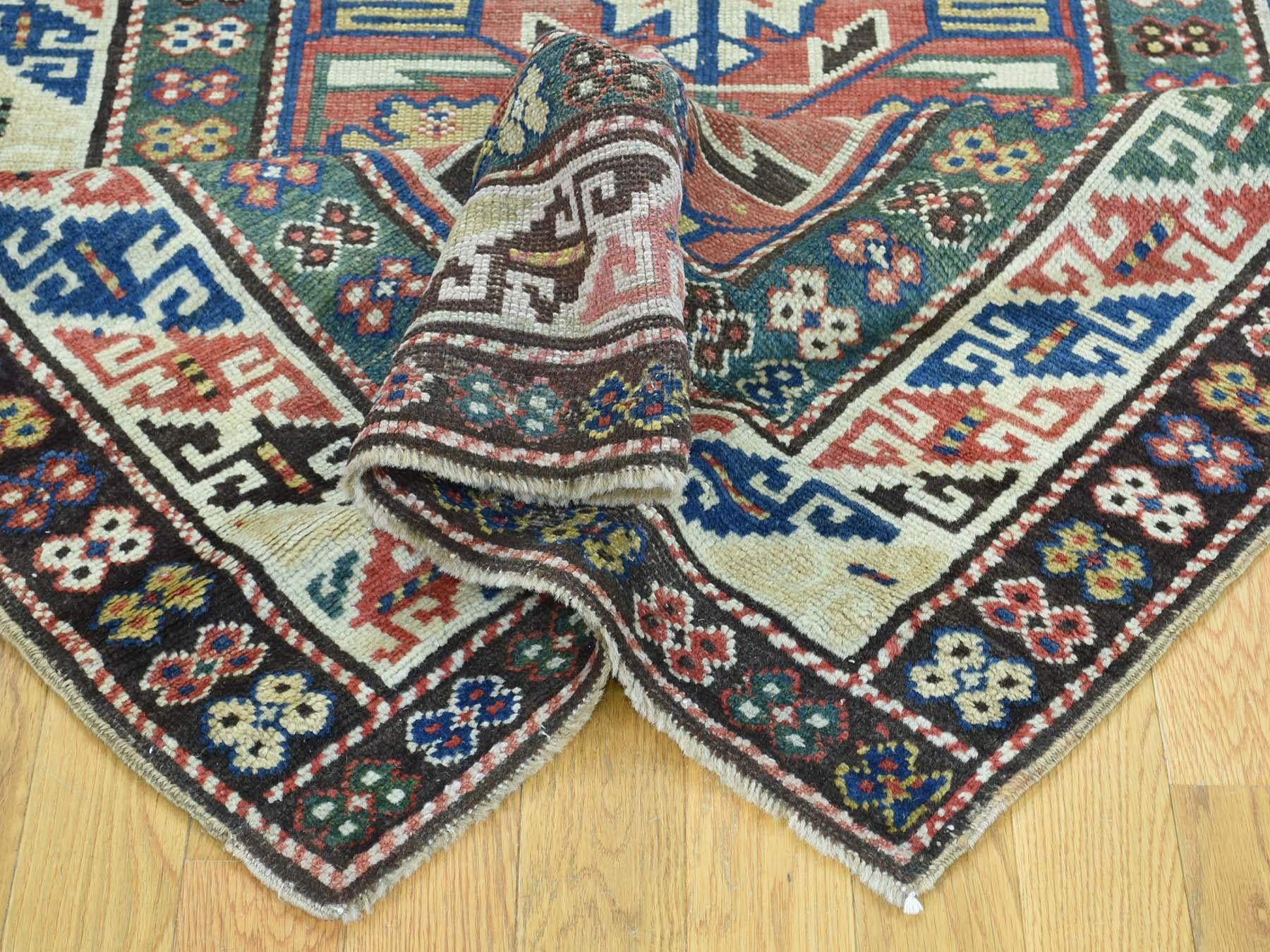This is a genuine hand knotted oriental rug. It is not hand tufted or machine made rug. Our entire inventory is made of either hand knotted or handwoven rugs.

Bring life to your home with this admirable antique carpet. This handcrafted Kazak