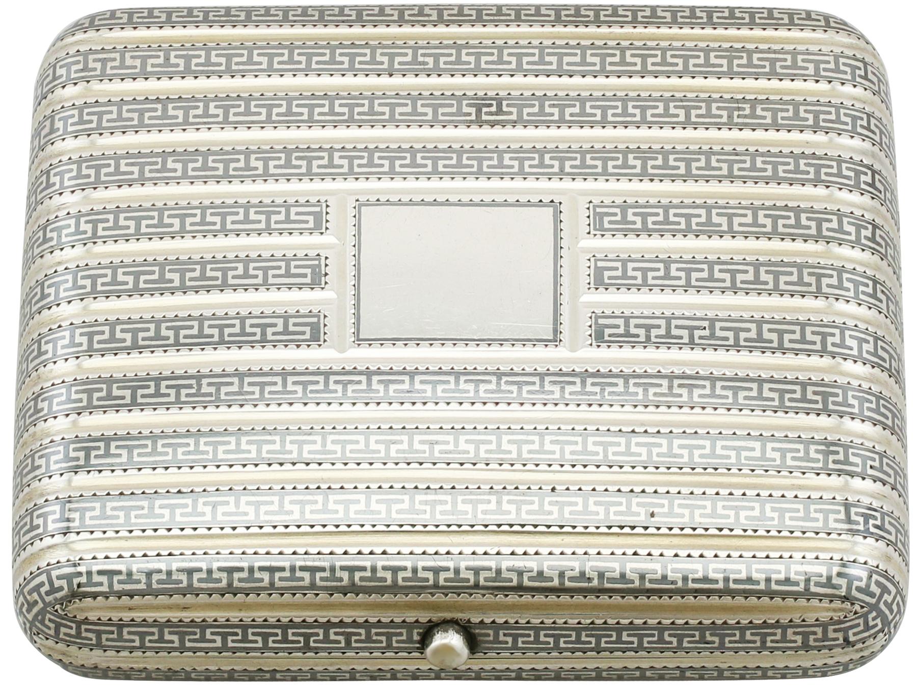 This exceptional antique Russian silver cheroot case has a rounded rectangular shaped form.

The surface of this antique cheroot holder is embellished with fine and impressive niello enamel Fret band ornamentation segmented with concave silver