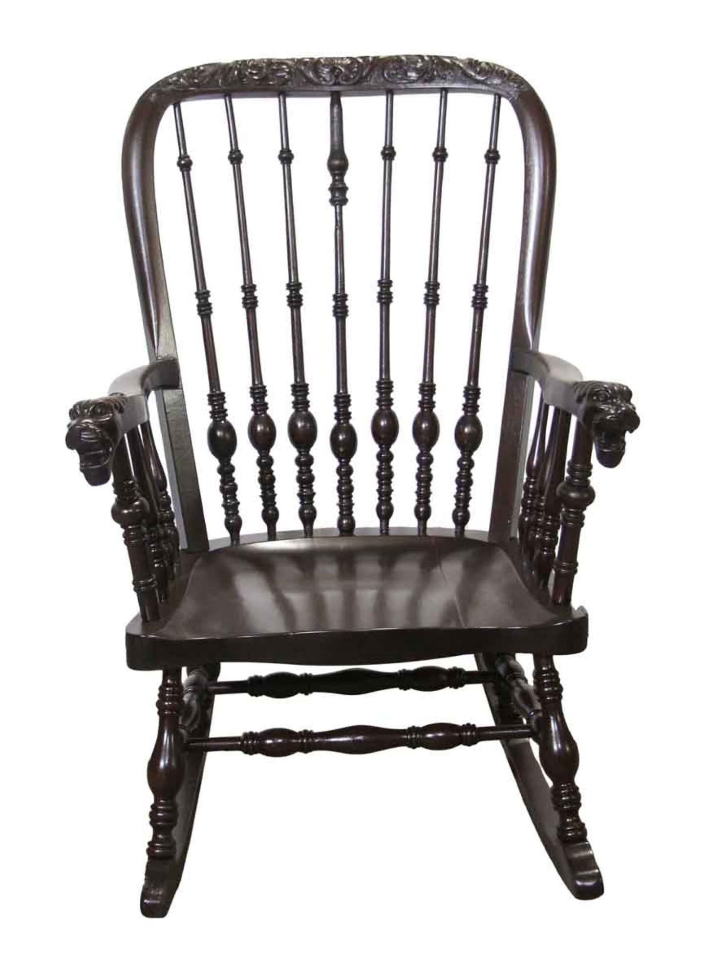 1890s antique dark tone oak carved Victorian rocking chair with griffon arm rests and floral carvings along the top part of the spindle back. This chair has been fully restored. This can be seen at our 400 Gilligan St location in Scranton, PA.