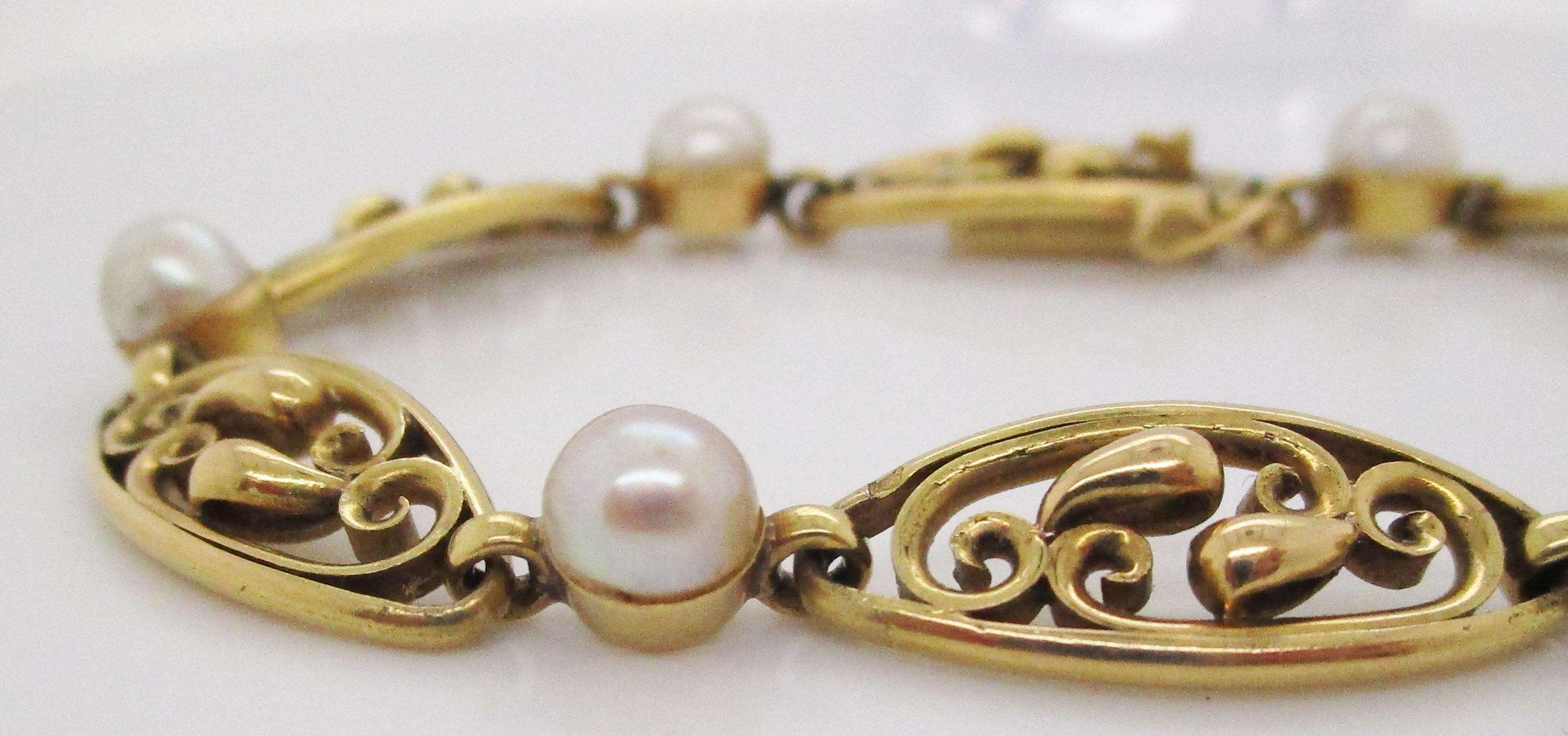 This lovely bracelet features a sophisticated combination of rich 18k yellow gold and GIA-certified natural pearls in an open, delicate 1890s style that is pure Art Nouveau beauty! The links of the bracelet have a delicate design that showcases the