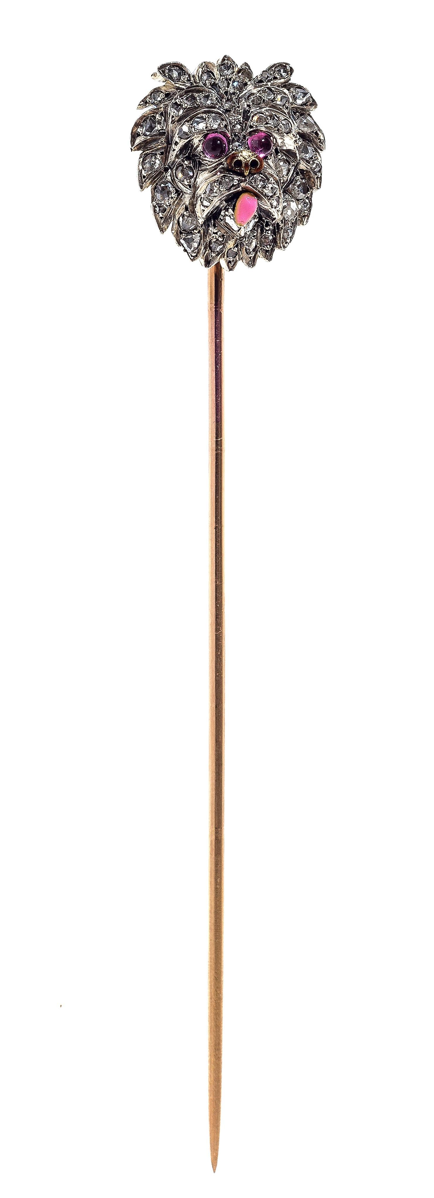 Naturalistically modelled stickpin of a dog of outstanding quality, possibly a Yorckshire Terrier. The lovely animal has with ruby eyes, a golden snout and a pink enamelled tongue. It's head is set with rose diamonds mounted in platinum, the