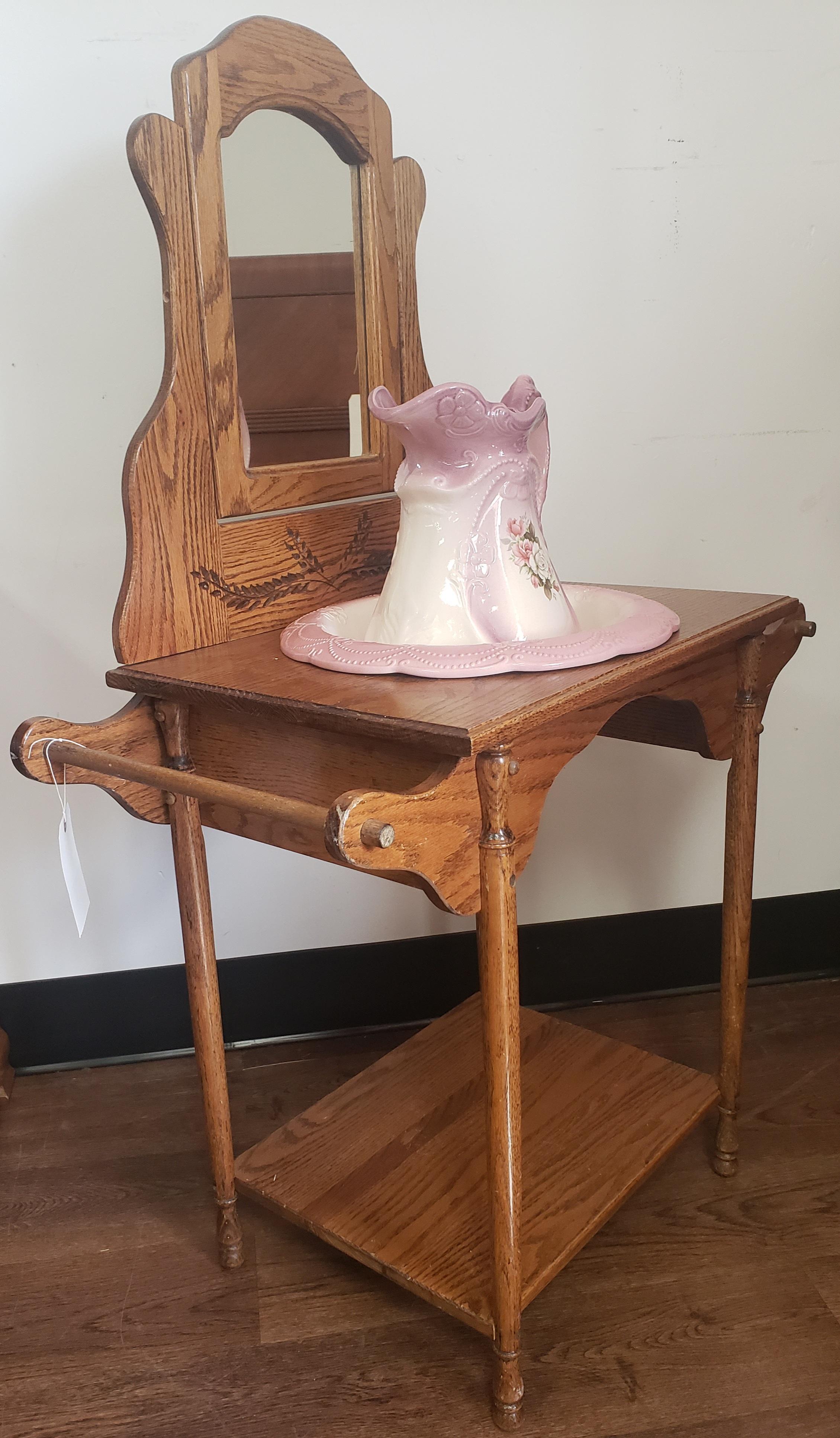 1890 English ironstone basin and pitcher on mirrored oak washstand in very good condition. Mirror seems to have been replaces and is in good condition. Measures 33.5