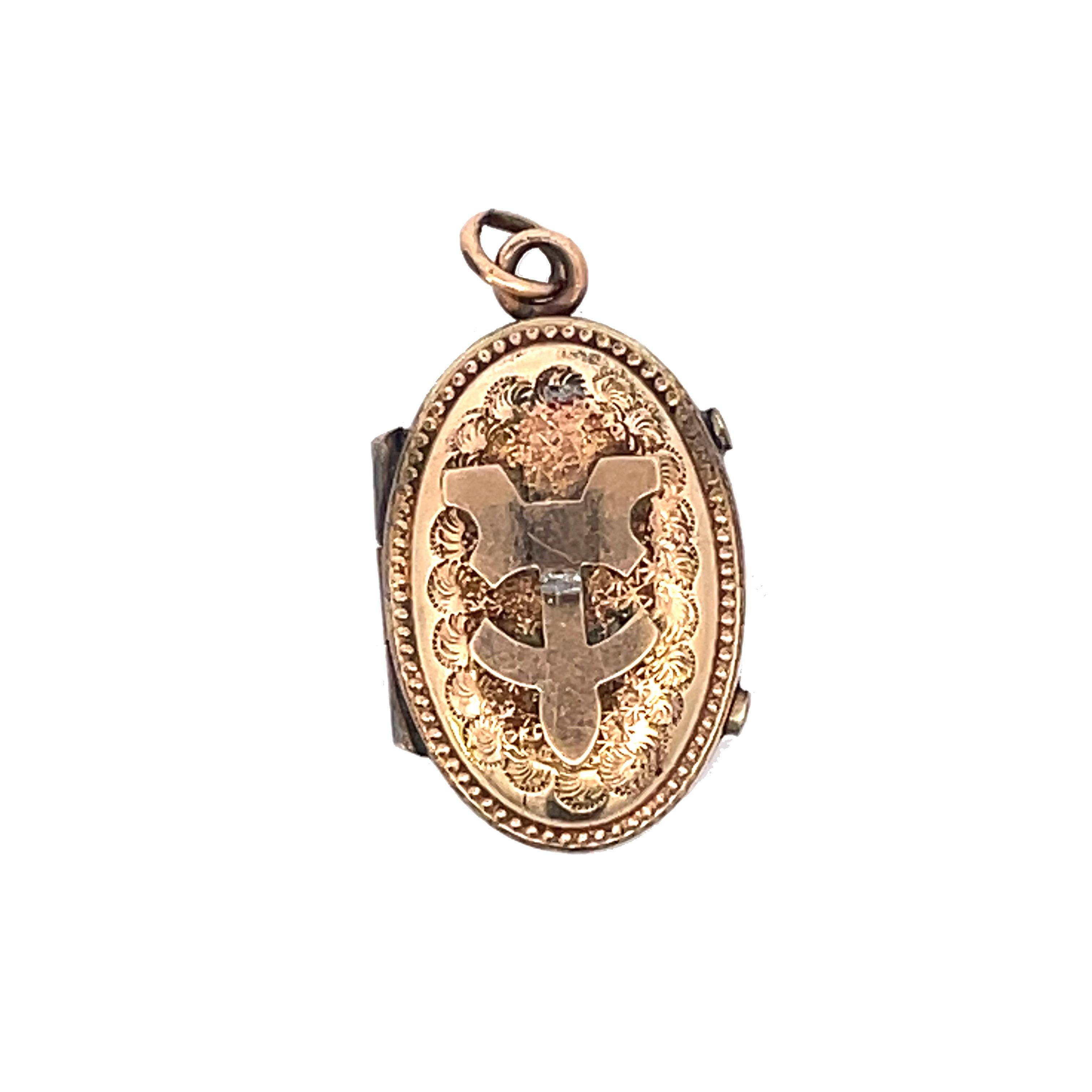 This is a splendid gold-filled locket from the Etruscan period that showcases intriguing and detailed engraving on both sides. Dainty and petite, the front of the locket has a beautiful engraved and textured surface with an intriguing decorative