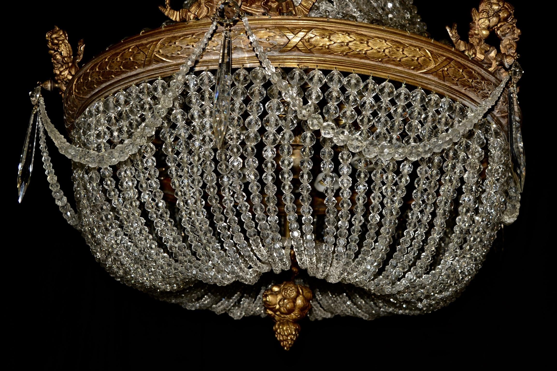 This beaded Empire basket chandelier has 15 lights. All the beads are made of genuine crystal and the drops are made of original Bohemia crystal. Chandelier has been restored but we have maintained the original shape and integrity of the late 19th