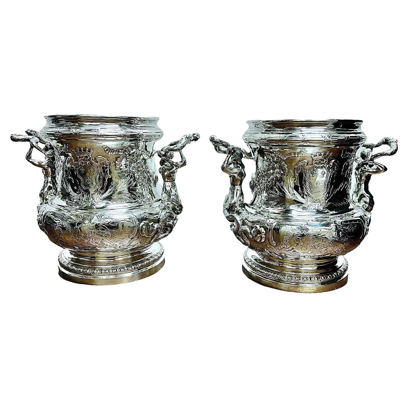 This exceptional pair of German Solid Sterling silver coolers, crafted in the year 1890, stands as a testament to the exquisite craftsmanship of their time. Created in the renowned workshops of Hanau by the skilled silversmith S. Rosineau and