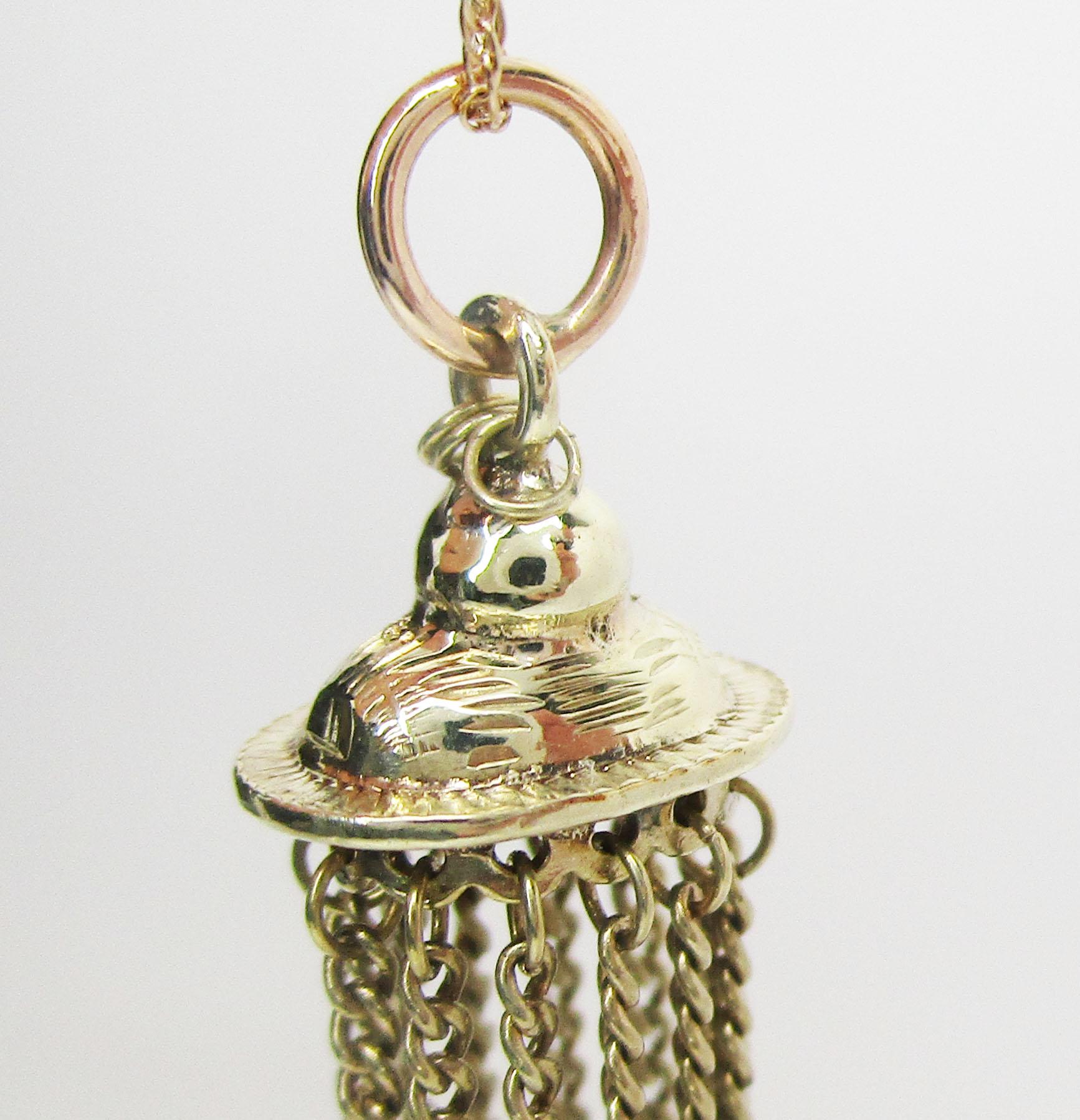 This beautiful Victorian tassel pendant is from the 1890s and is in 14k green gold. The pendant is a unique tassel design, and each chain of the tassel is accented with a bright white seed pearl terminus! The tassel design is very fluid and has a