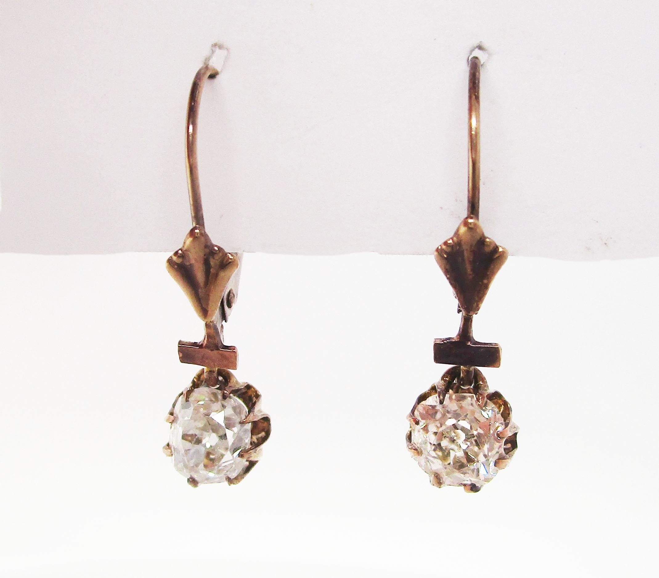 These gorgeous Victorian earrings are in 14k yellow gold and feature two stunning old mine-cut diamond centers. The earrings have the elegant color of aged gold that can only come with the passage of time! The gold forms the perfect frame for the