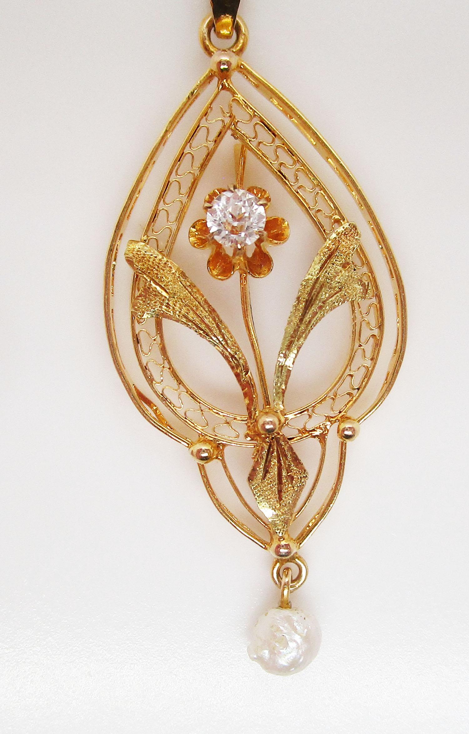 This is an enchanting Victorian pendant in 14k yellow gold with an open, lace-like design featuring a buttercup set diamond at the very center and a delicate natural pearl dangle at its terminus! This is the perfect Victorian pendant! The