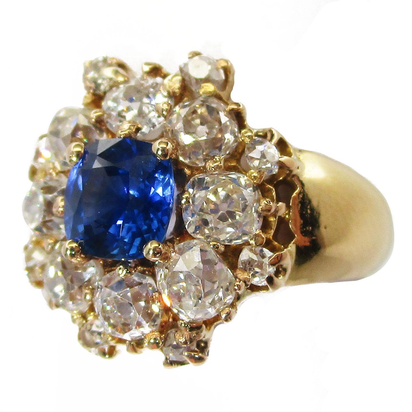 This ring boasts a brilliant, deep blue natural colored sapphire at its center that is nearly one carat! The center stone is cushion cut and such a rich blue that even in the soft evening light, it boasts royal blue depth! The sapphire is surrounded