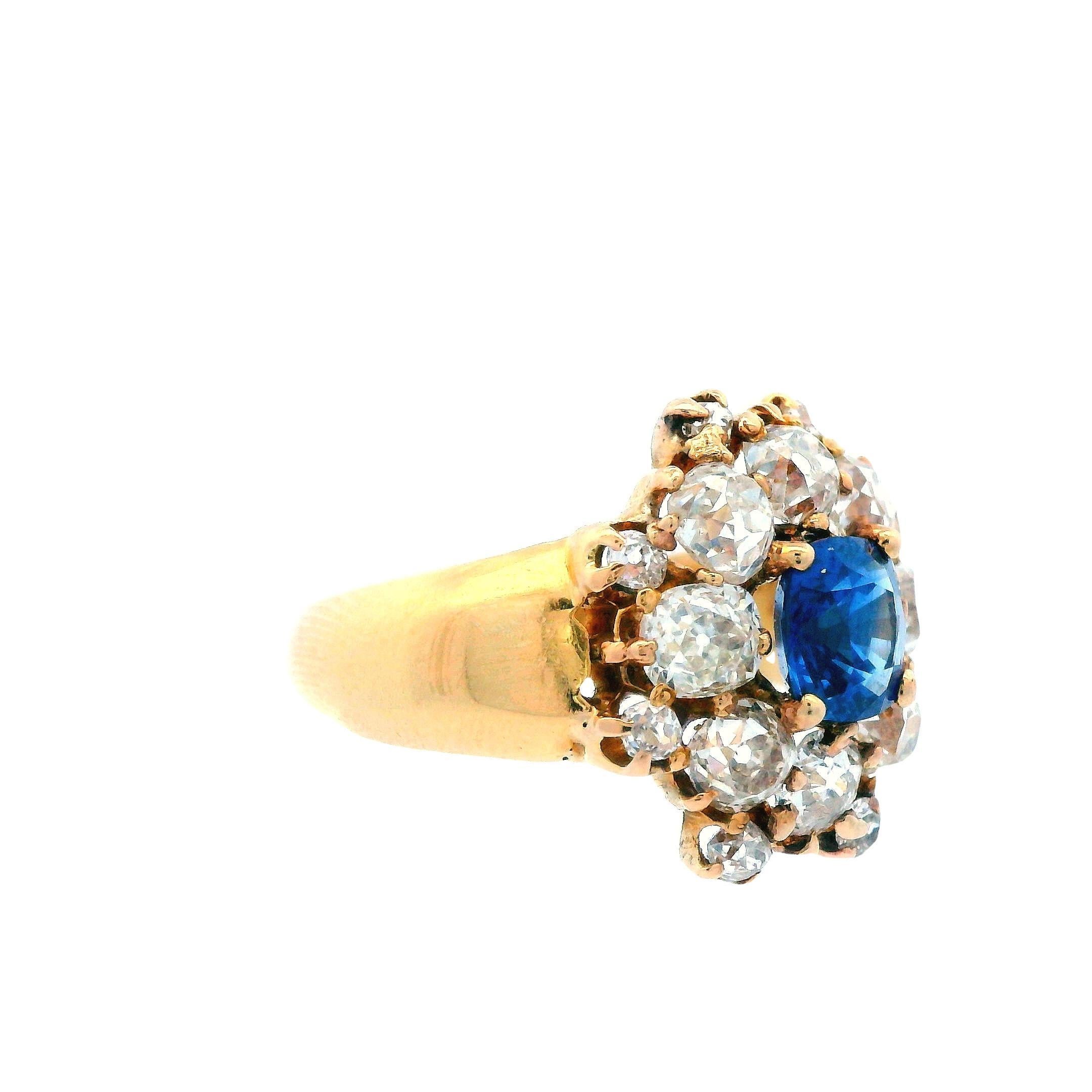 This ring boasts a brilliant, deep blue natural colored sapphire at its center that is nearly one carat! The center stone is cushion cut and such a rich blue that even in the soft evening light, it boasts royal blue depth! The sapphire is surrounded