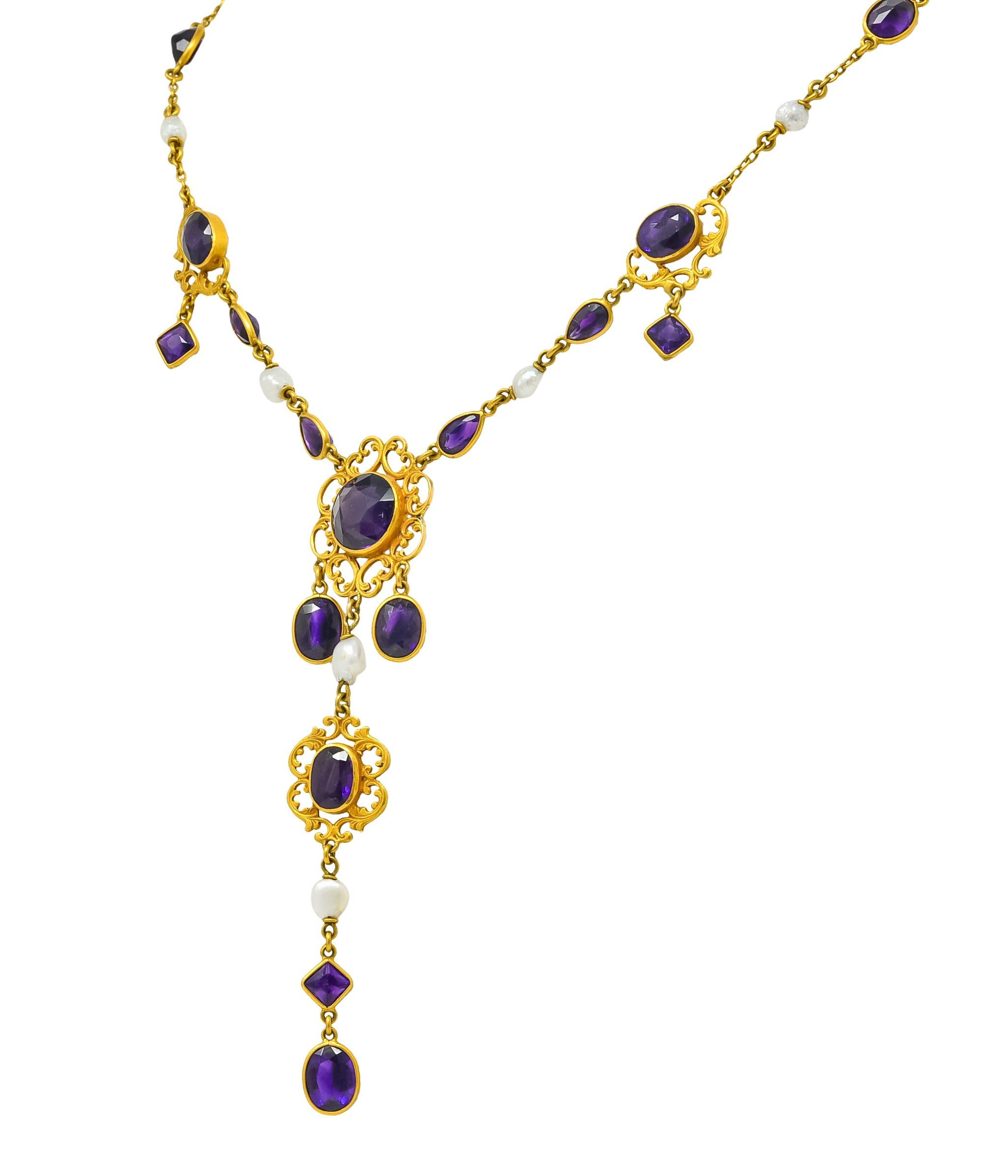 Necklace designed with four scrolled whiplash stations featuring small articulated drops and one very long dramatic drop

Set throughout by bezel set amethyst varying in size and shape, all are very well matched and medium-dark purple

Accented