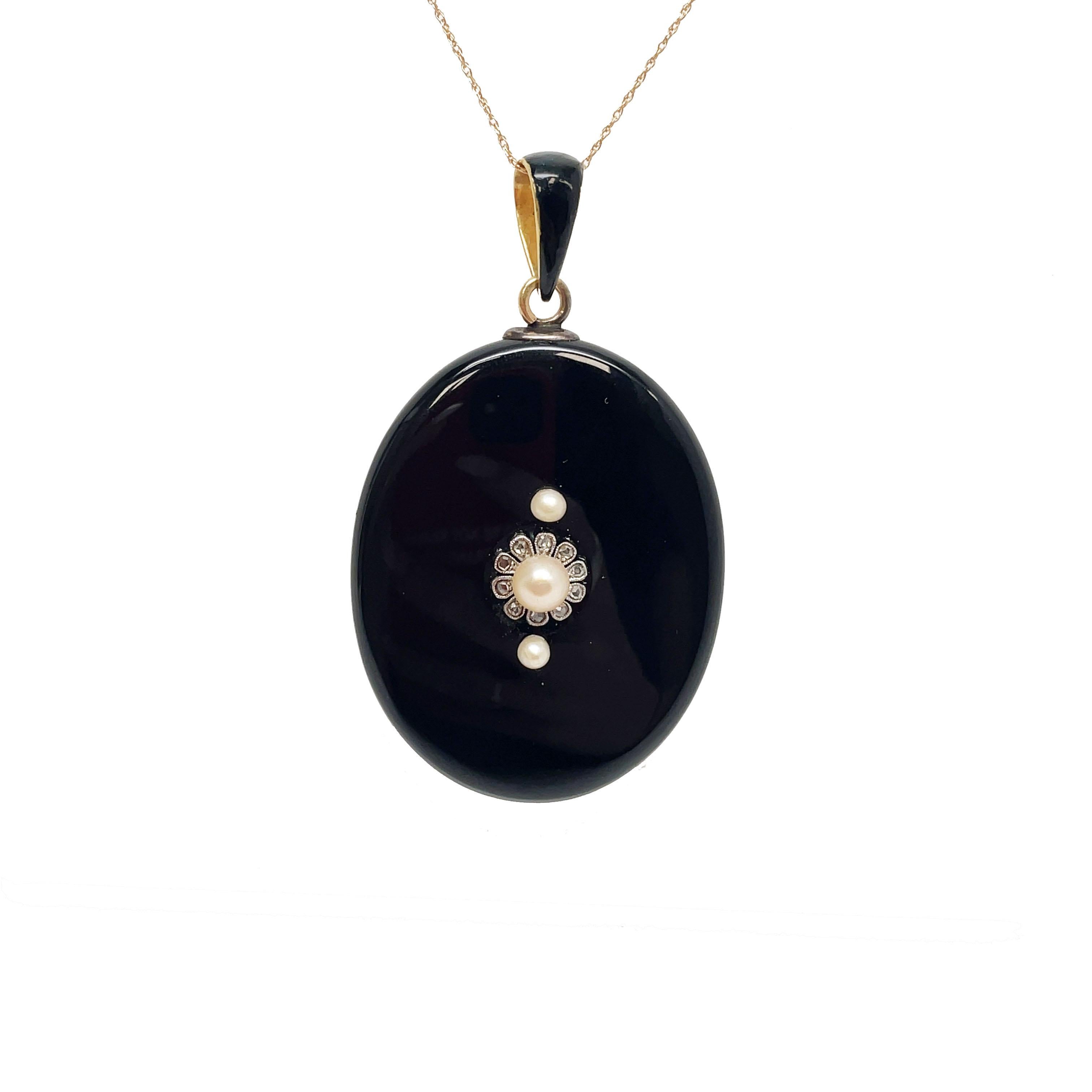 This is a spectacular 1890 Victorian Black Onyx, Diamond, and Pearl Locket! This locket features 10 lovely rose-cut diamonds that surround one of the pearls in a lovely petal-like pattern. The locket is composed of Black Onyx and has an enamel bail