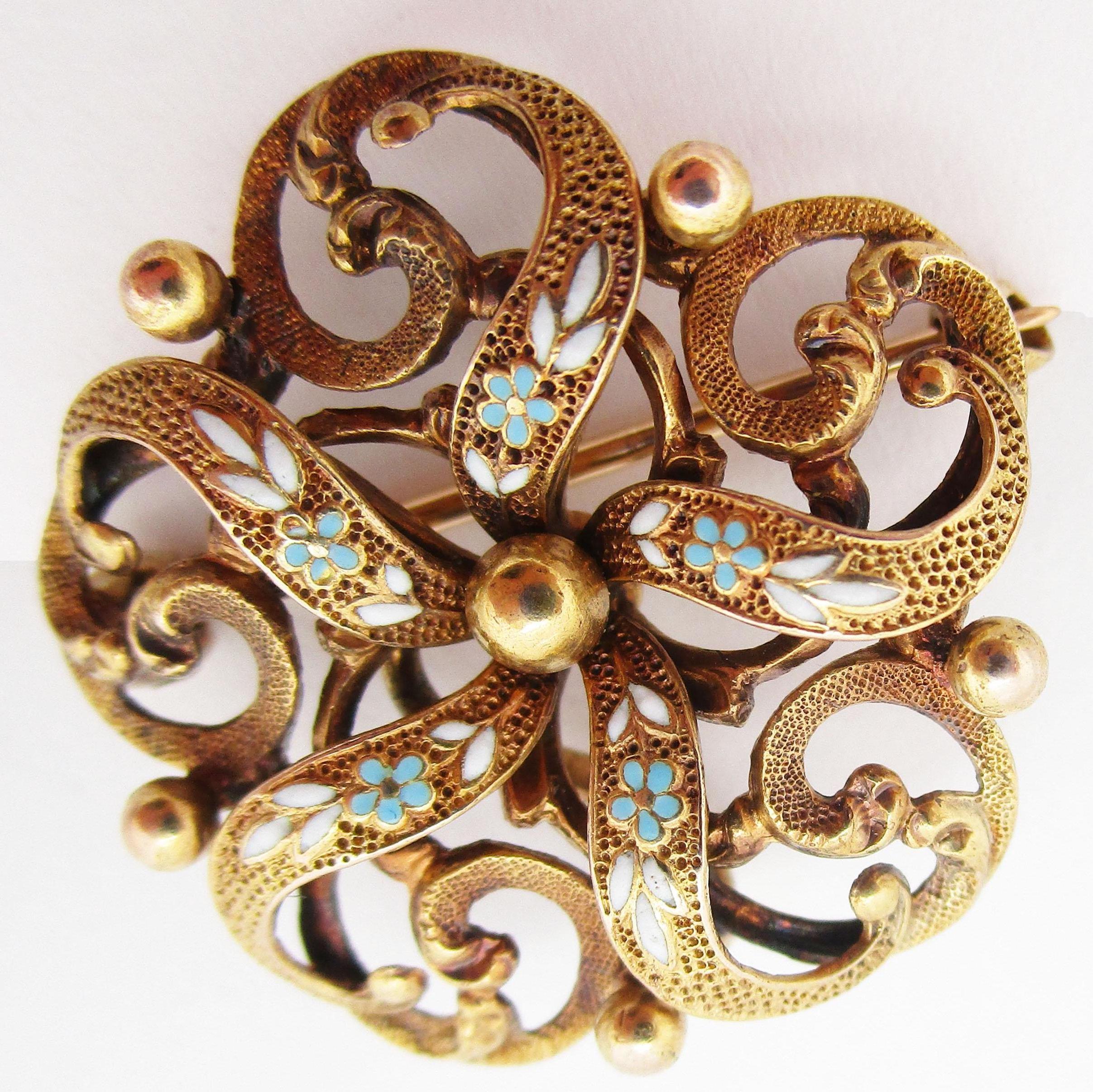 This is a beautiful Victorian pin by Krementz in 14k yellow gold with stunning enamel detailing from 1890. The enamel is in fantastic shape! The 14k gold has a textured appearance that gives this pin an incredible dimensional feel. The enamel