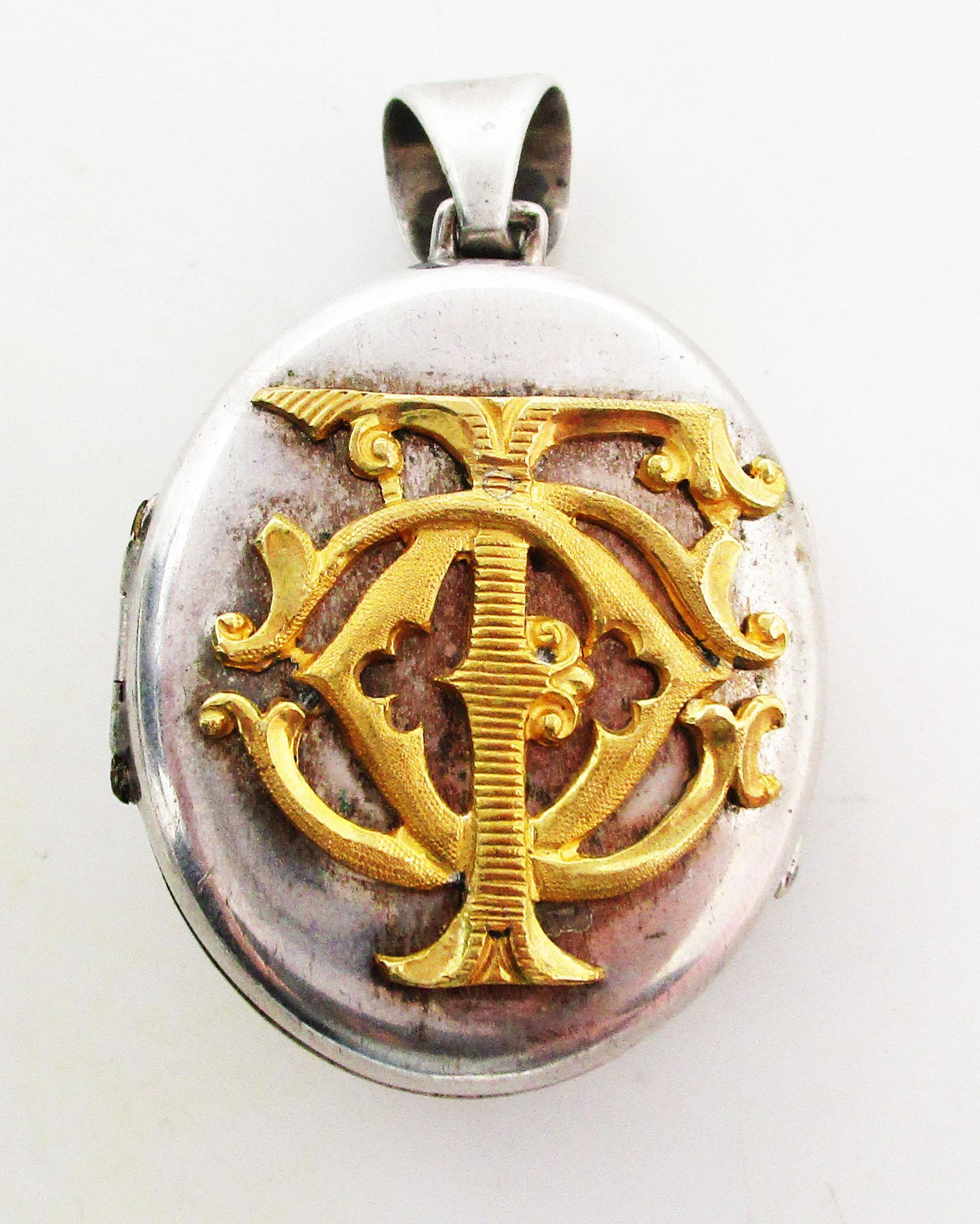 This is an incredible large Victorian locket in sterling silver featuring a remarkable gold washed royal fusiliers emblem! The locket has a vermeille accent on each side. One side features the symbol of the royal fusiliers over a pair of crossed