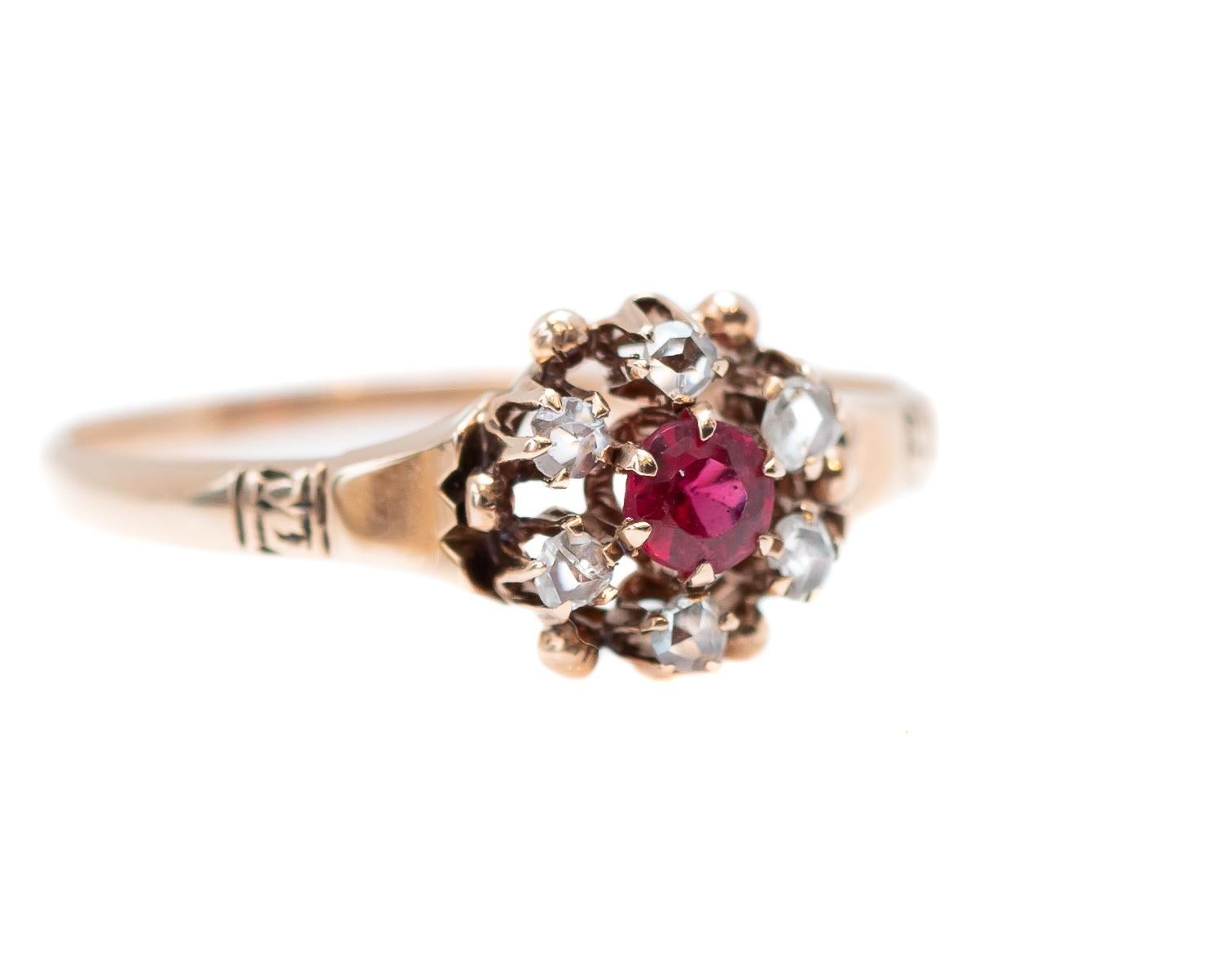 1890s Victorian Era 9 Karat Gold Ring featuring 0.33 Carat Diamond Halo and Ruby 

Features:
Floral Design
0.33 carat total Gemstones
Pinkish Red Ruby Center Stone, 6-prong set 
Old Mine Diamond Halo, 5-prong set side stone

Ring measures
