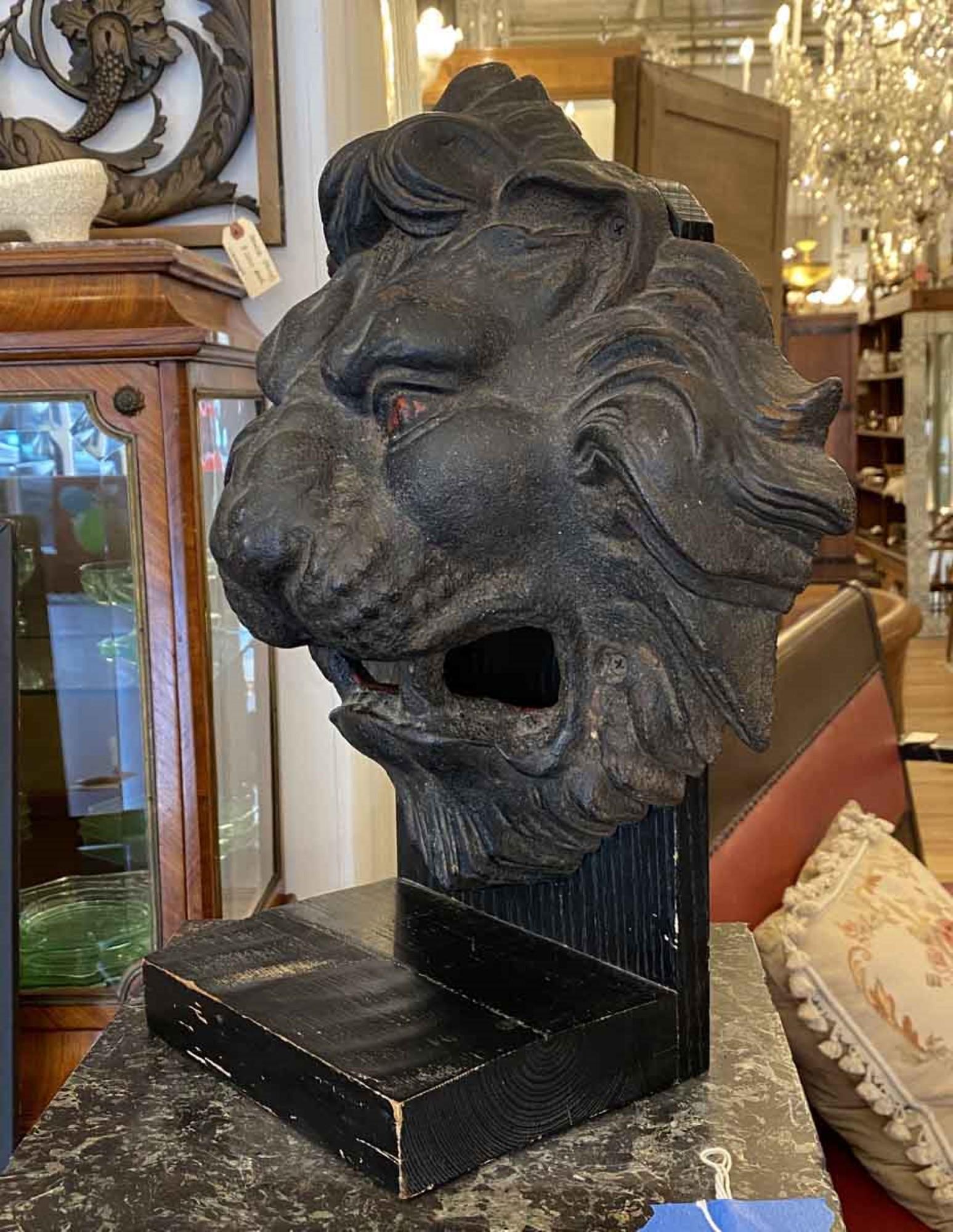 Great looking 1890s antique cast iron lion head mounted on a painted black wooden stand. Head features a nice blackened patina. This can be seen at our 333 West 52nd St location in the Theater District West of Manhattan.