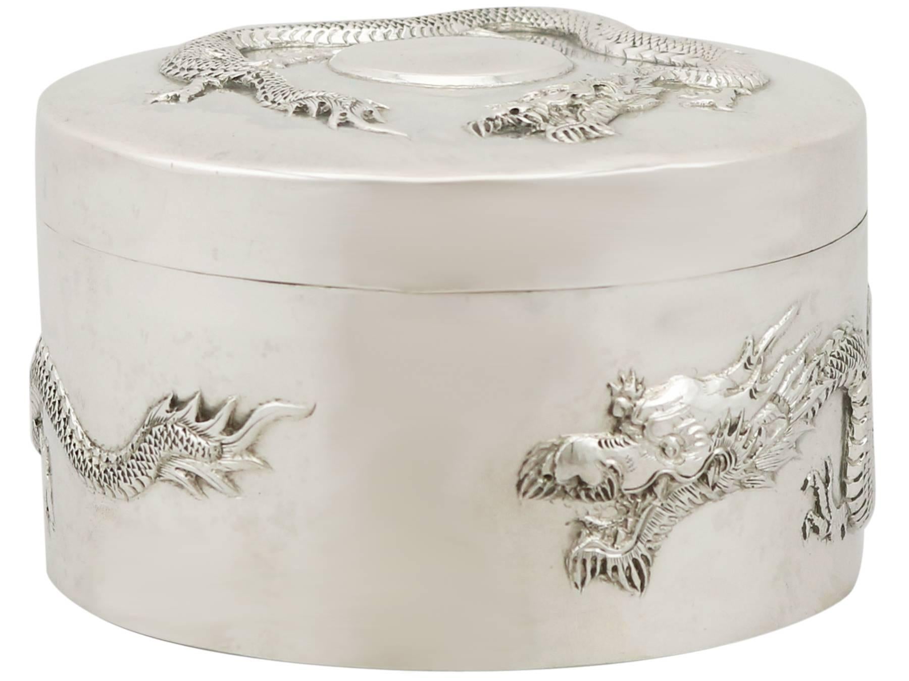 An exceptional, fine and impressive antique Chinese Export silver dragon box, an addition to our collection of boxes and cases.

This fine antique Chinese Export Silver (CES) box has a cylindrical form.

The surface of the body is embellished