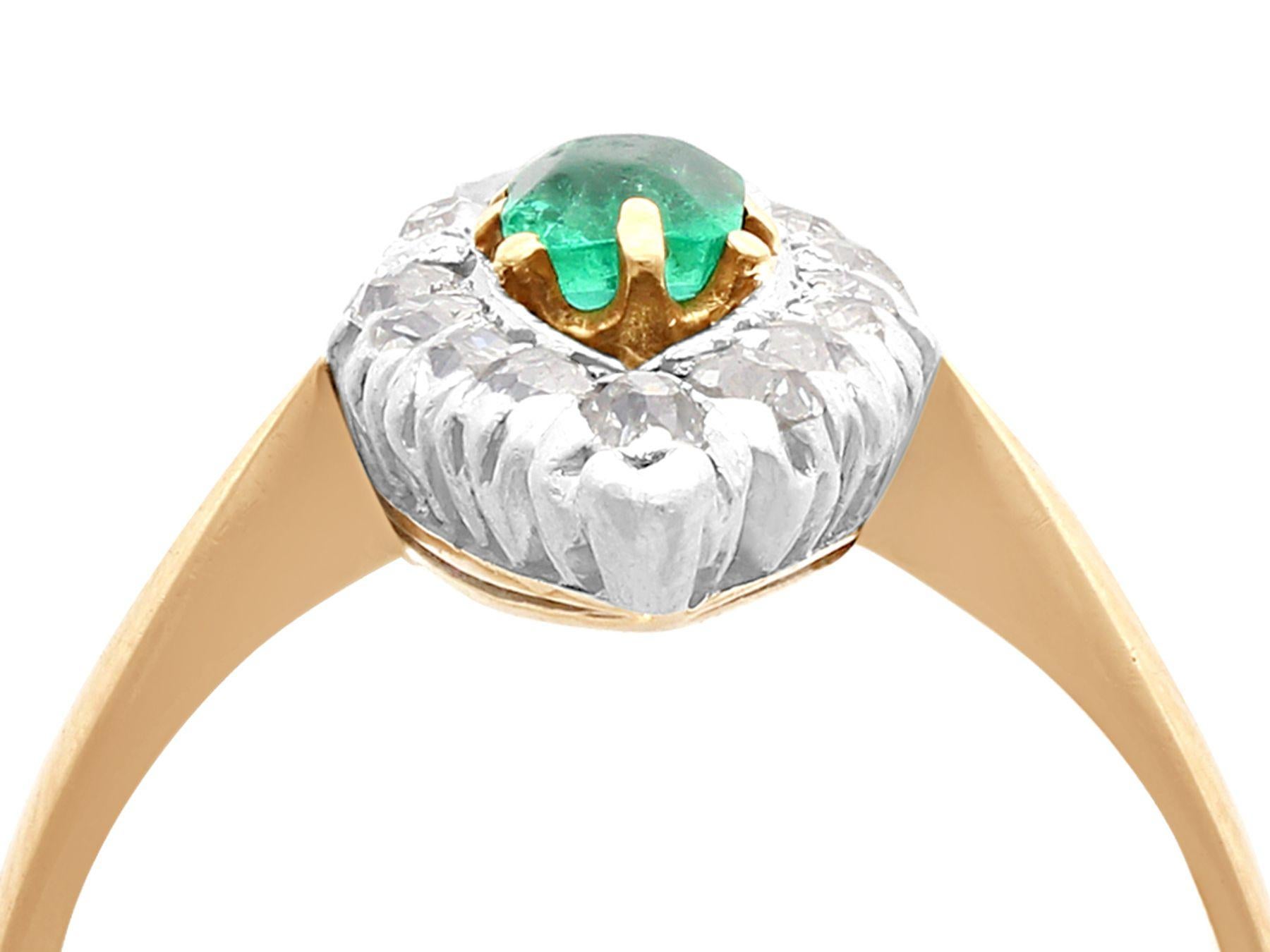 A fine and impressive antique 0.32 carat natural emerald and 0.48 carat diamond, 14 karat yellow gold, platinum set marquise dress ring; part of our antique jewelry and estate jewelry collections

This impressive antique emerald and diamond dress