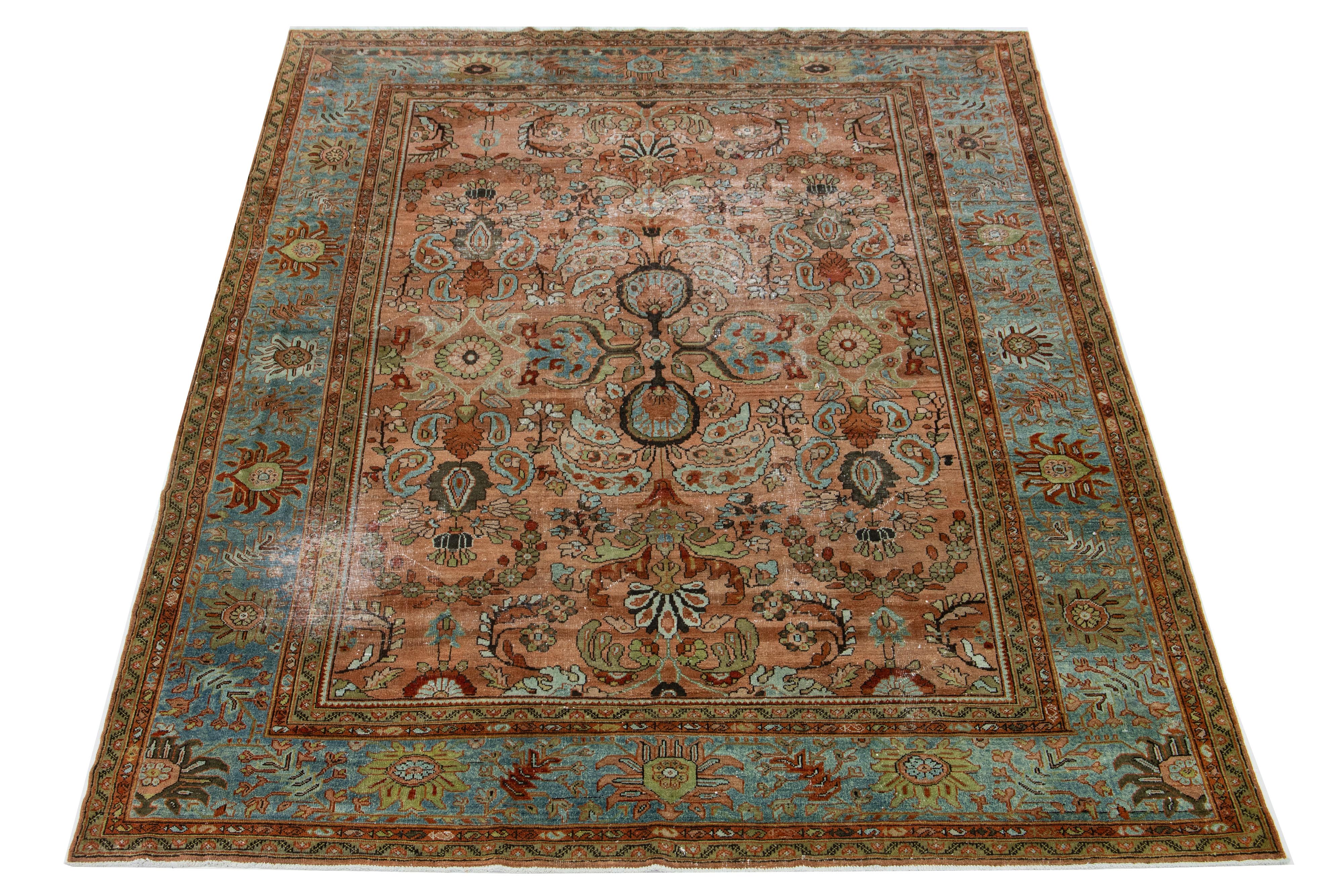 Beautiful hand-knotted 1890s antique Sultanabad wool rug with an orange-rust color field. This Persian rug has orange, green, and blue accent colors in an all-over floral design. This Classic rug design is made to last with a strong wool weave from