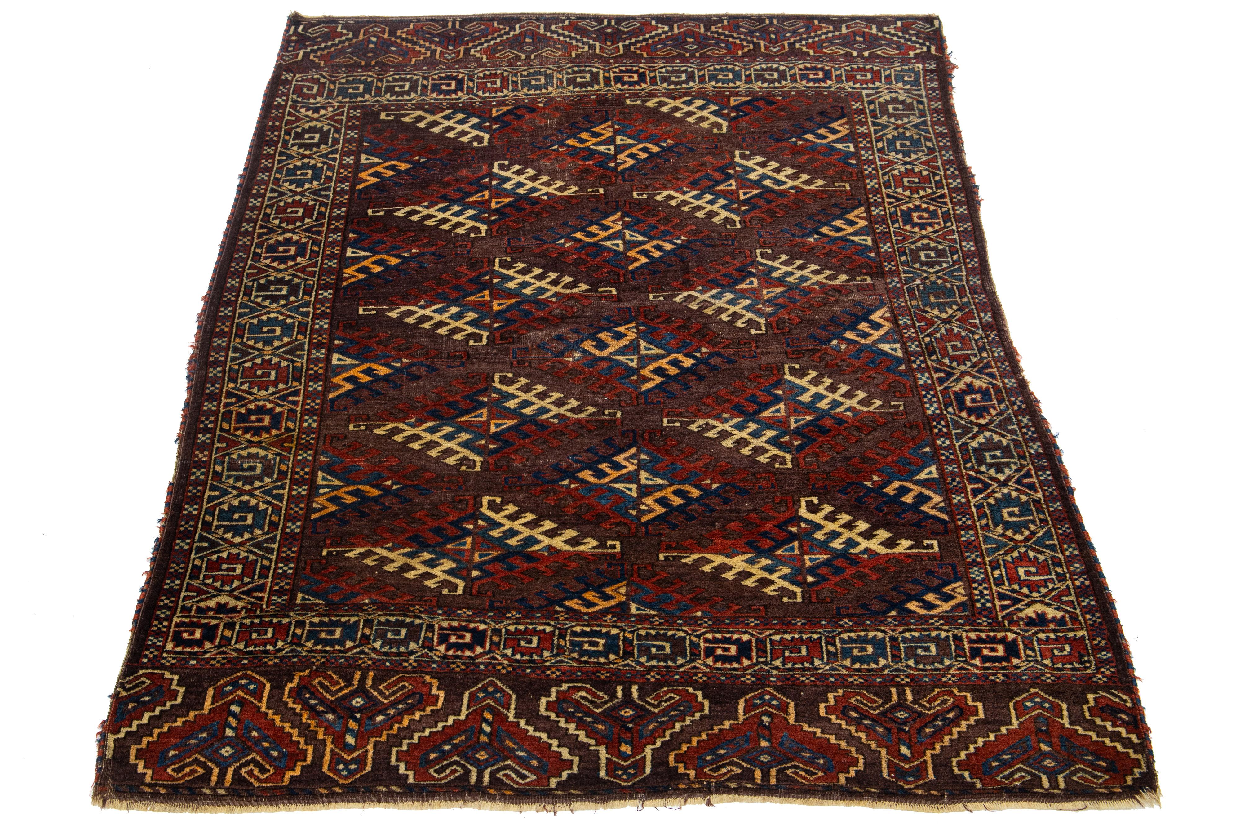 This elegant antique Turkmen rug is hand-knotted with high-quality wool and features a warm brown-colored field. The design showcases a captivating Gul pattern adorned with shades of red, orange, beige, and blue.

This rug measures 4'2