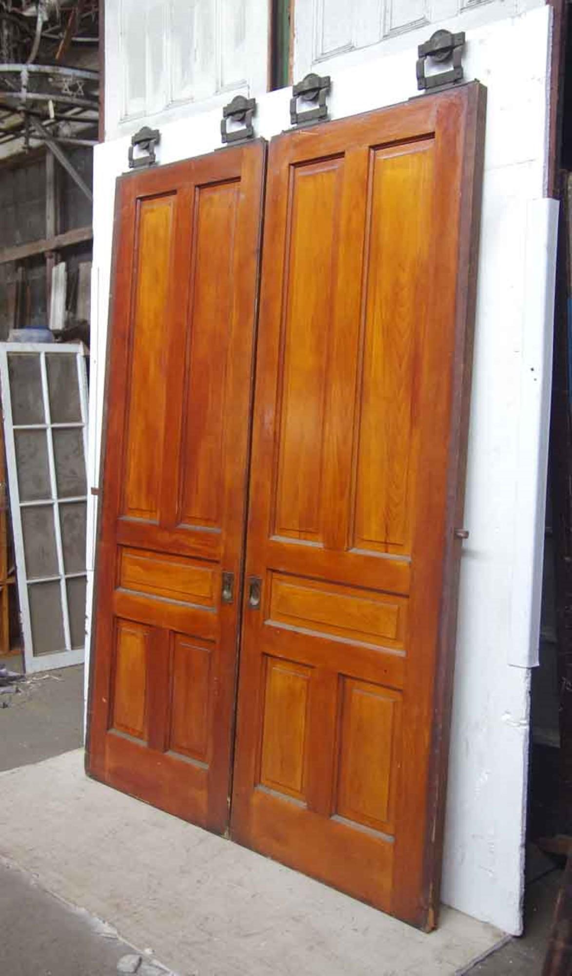 1890s pair of medium tone wood pocket doors with five panels each. Original hardware included. Measures: 89.5 inches x 62.5 inches. This can be seen at our 400 Gilligan St location in Scranton. PA.