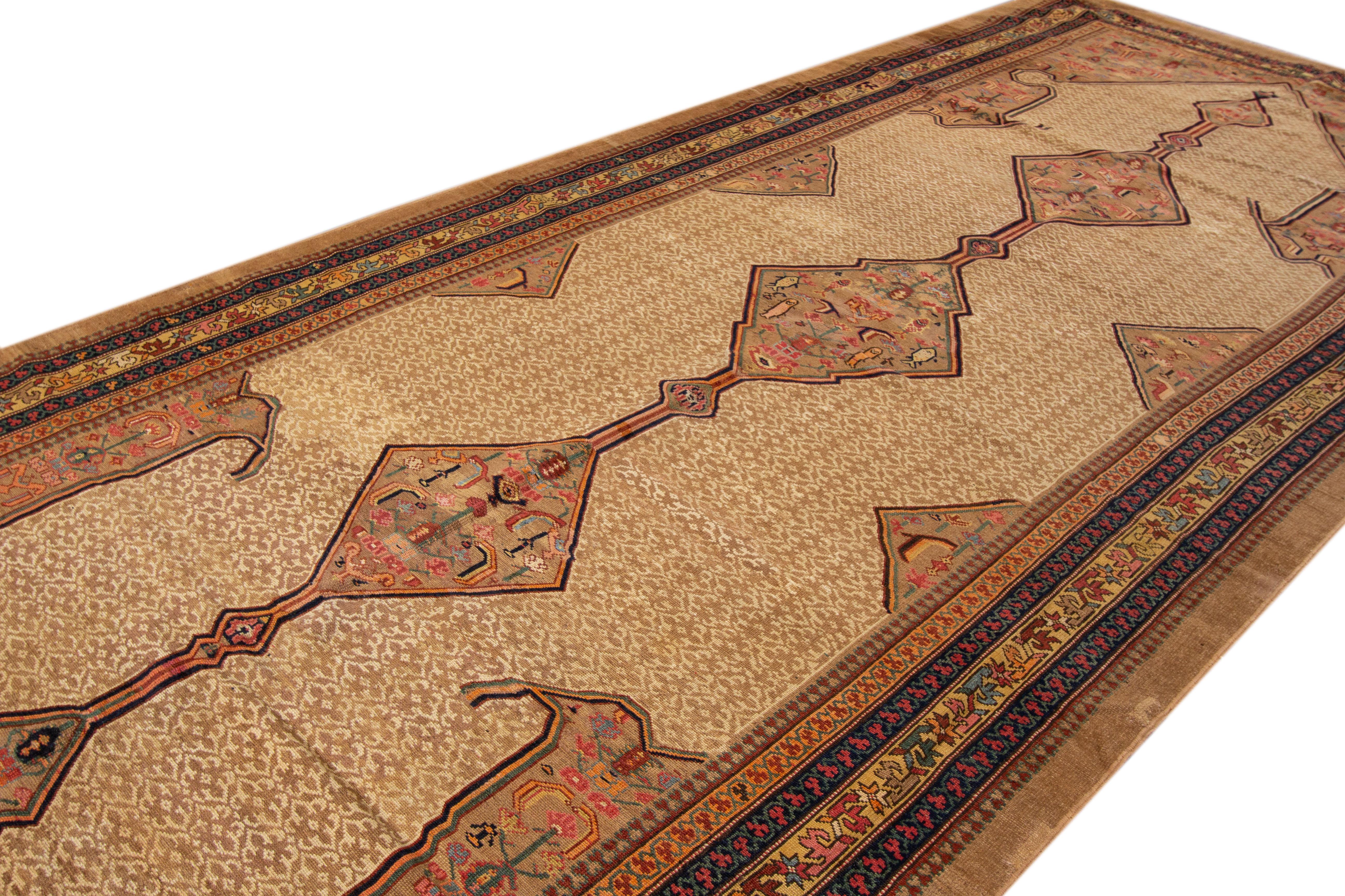 Antique Persian Serab hand-knotted wool rug with a tan and brown color field. This piece has multicolor accents in a beautiful classic tribal motif.

This rug measures: 6'6