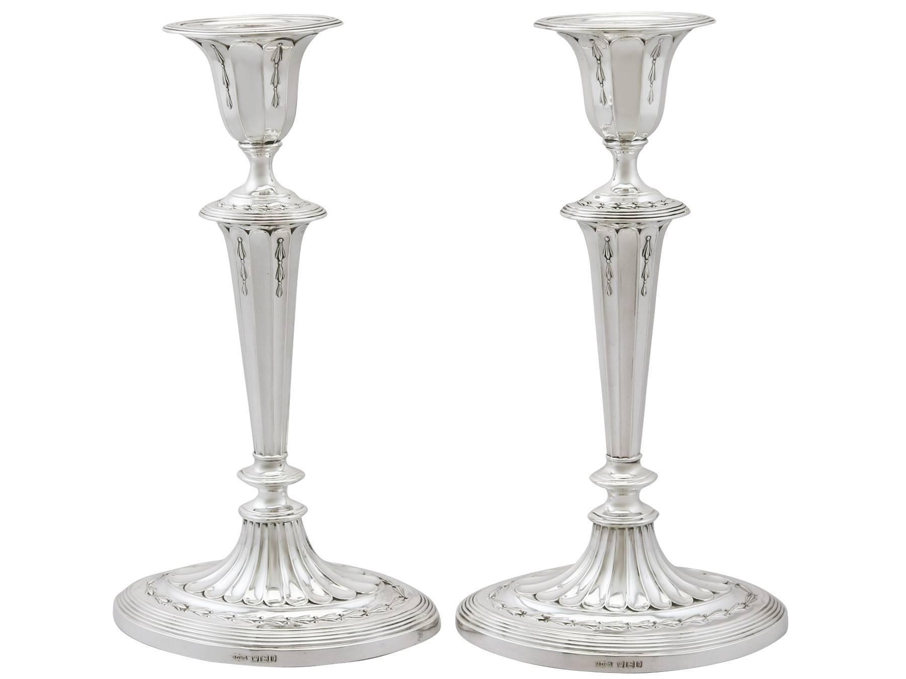 An exceptional, fine and impressive pair of antique Victorian English sterling silver candlesticks made by James Dixon & Sons; an addition of our ornamental silverware collection.

These exceptional antique Victorian Sheffield sterling silver