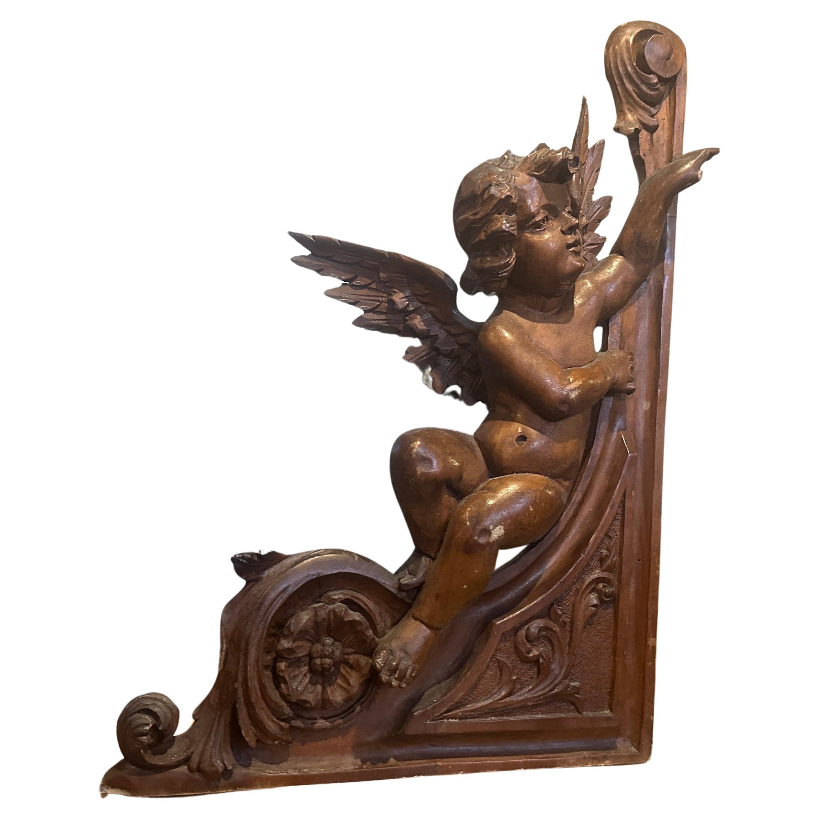 This art nouveau sicilian carving it was part of a larger composition from a piece of furniture, it's in original very good conditions. The walnut wood has been a suitable choice for its warm tones and fine grain. The angel fragment features sinuous