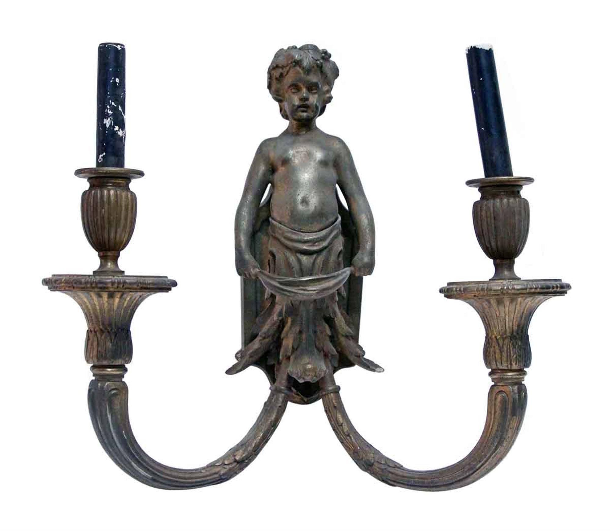 1890s cast bronze cherubic two-arm candlestick scones with astounding detail. Priced as a pair. This can be seen at our 400 Gilligan St location in Scranton, PA.