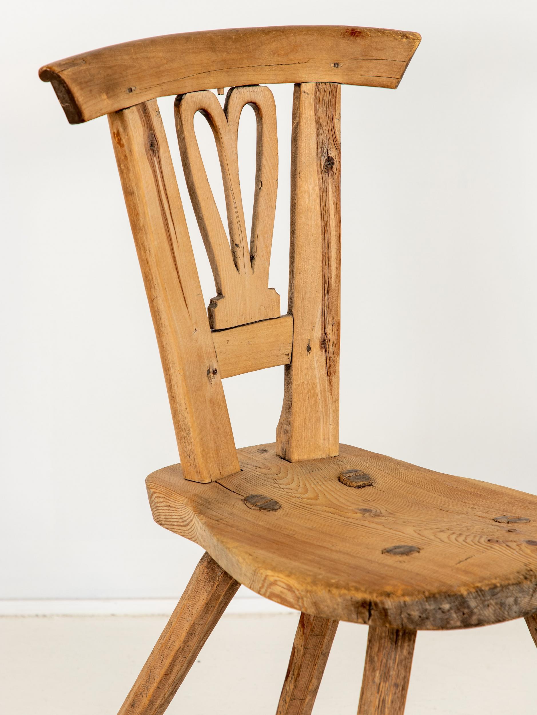 Small oak chair in the English Arts & Crafts style with four splayed legs.