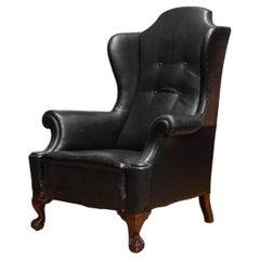 1890s English black leather 'Chippendale' wingback armchair