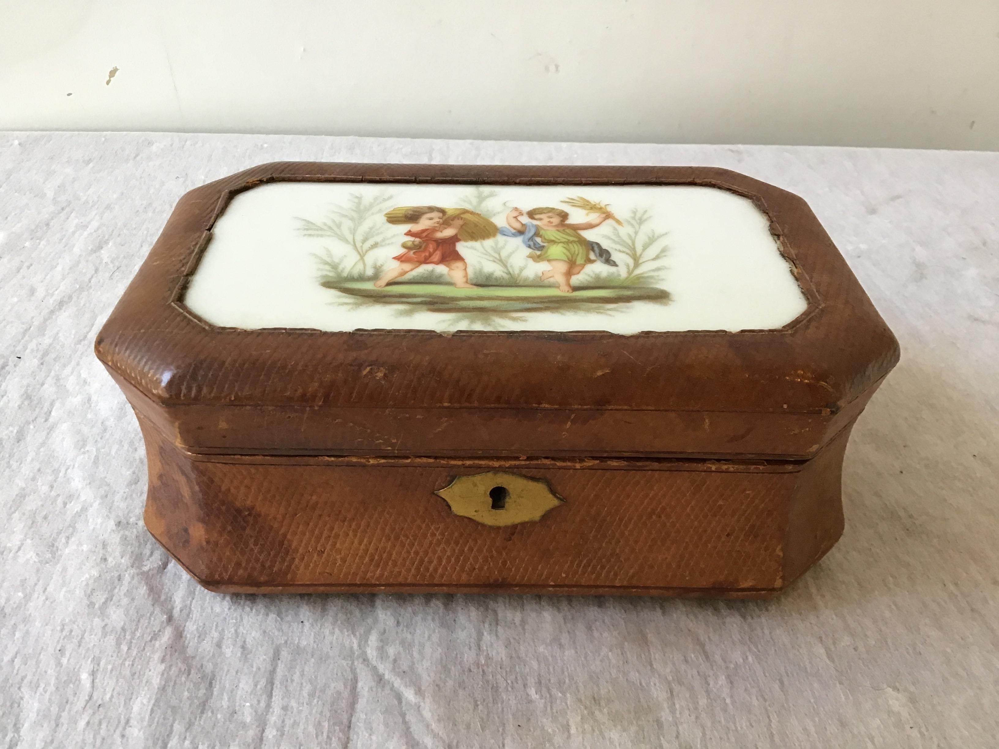 1890s French leather box. Ceramic plaque of children on top.