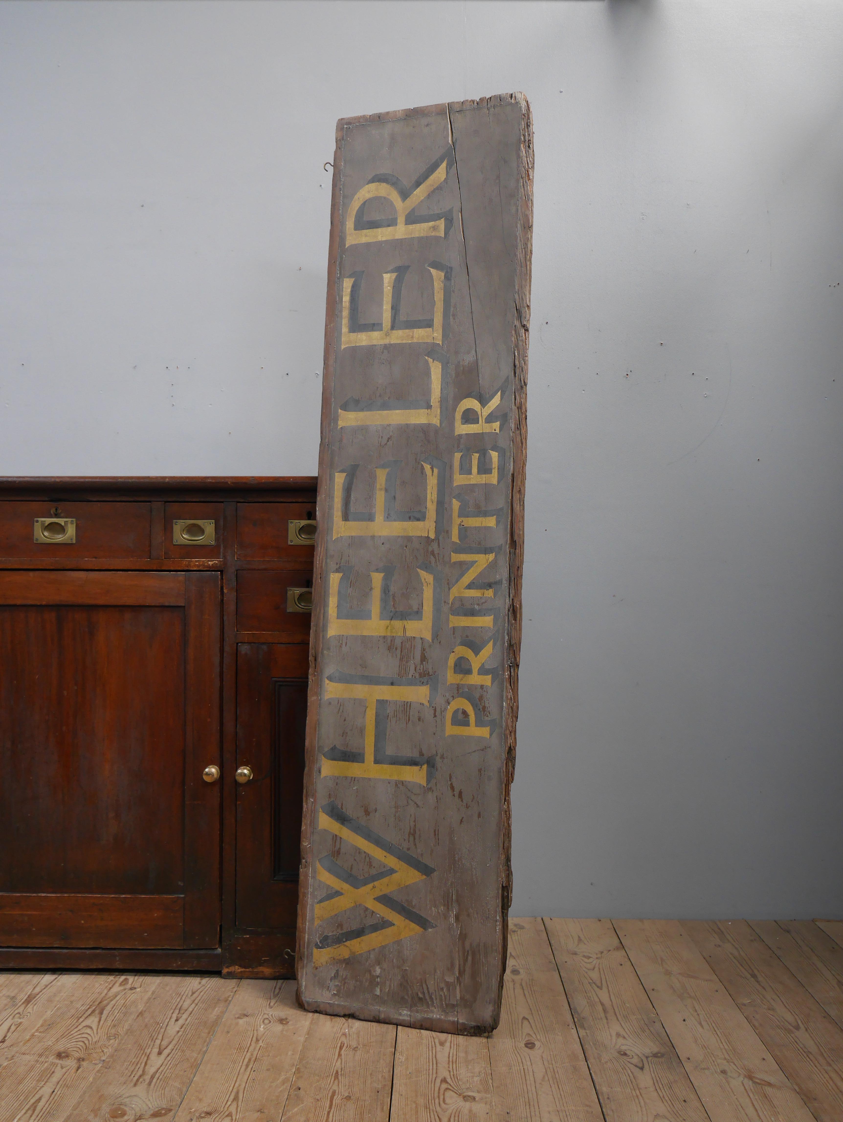 An early printer's trade sign.
A wonderful 19th century painted timber trade sign for 'Wheeler' printer's, delightfully original & untouched with the perfect patina. The sign is double sided with the bold gilt lettering with a black shadow expertly