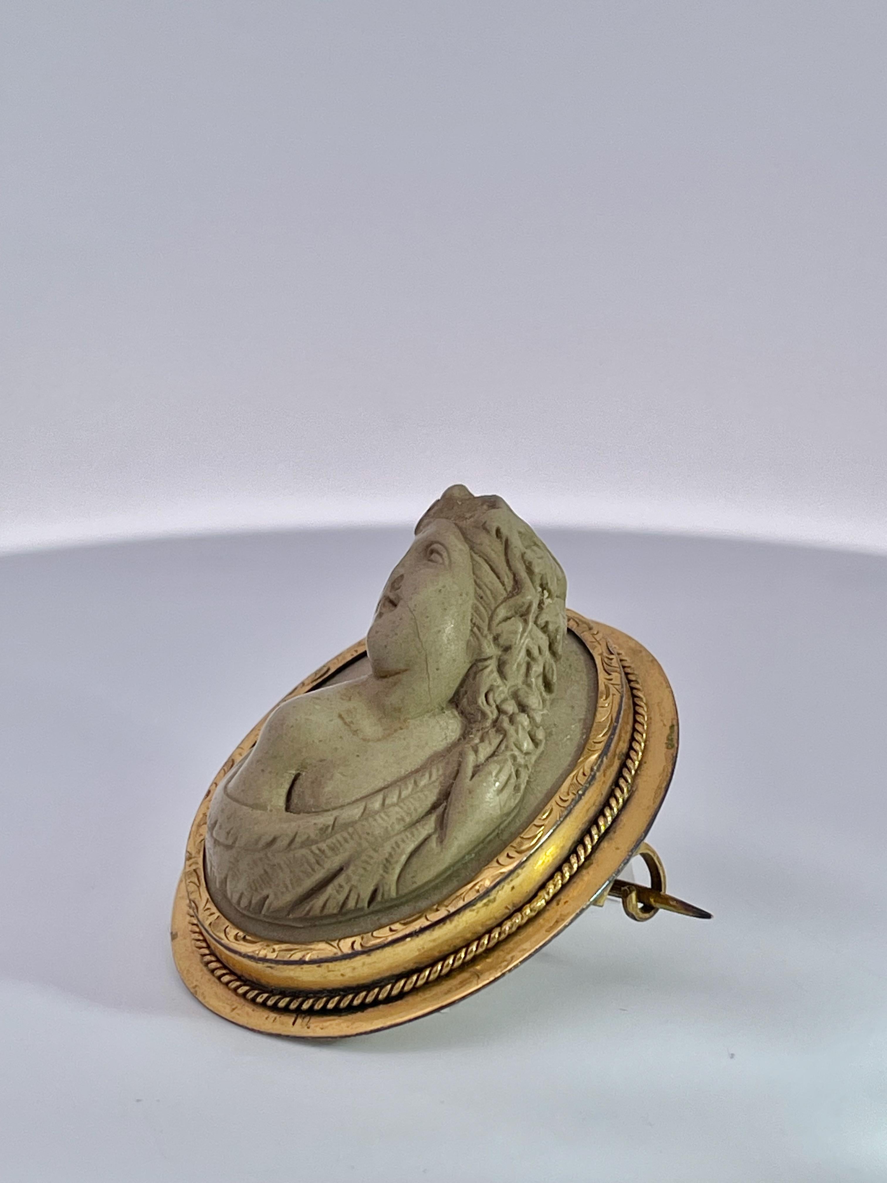 This piece carved in the 1890's is truly lovely.  This Cameo depicts a lady with long flowing hair and a provocative  pose with head over her bare shoulder.  The face is lovely and she is holding her dress up with one hand.  This was carved by a
