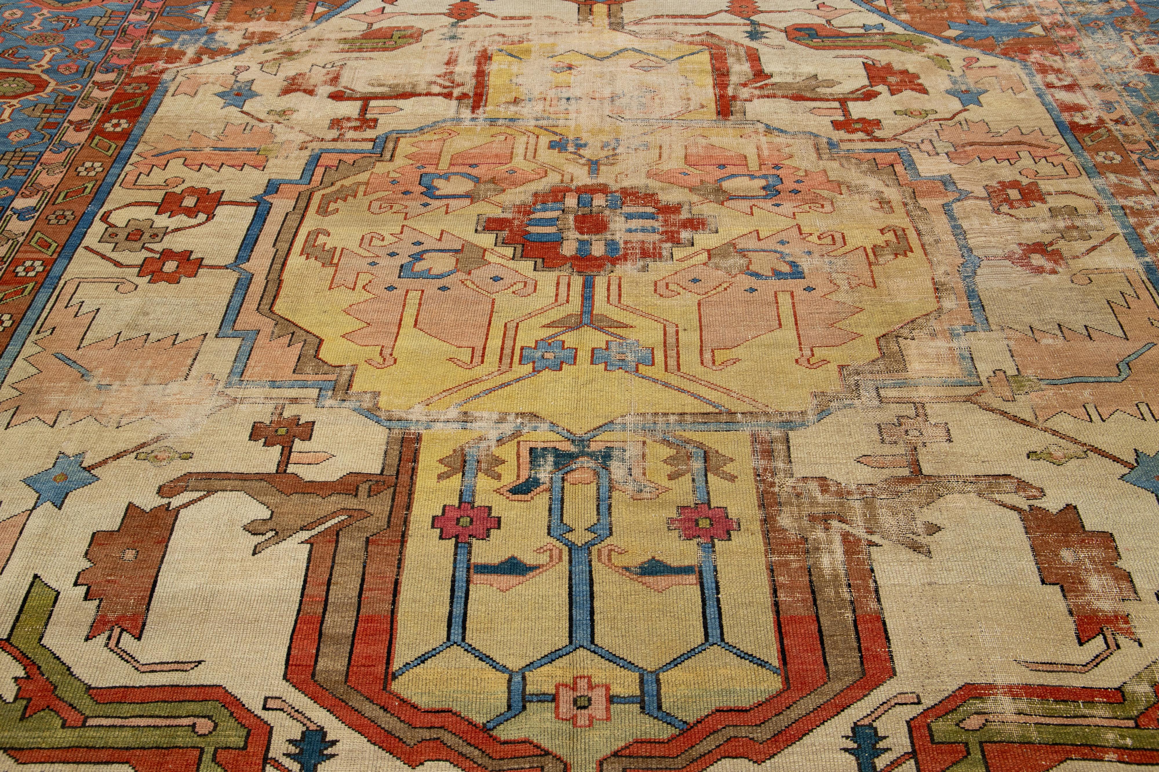 This hand-knotted wool Persian Serapi rug features a captivating medallion pattern on a beige field, adorned with multiple shades of color.

This rug measures 9'8