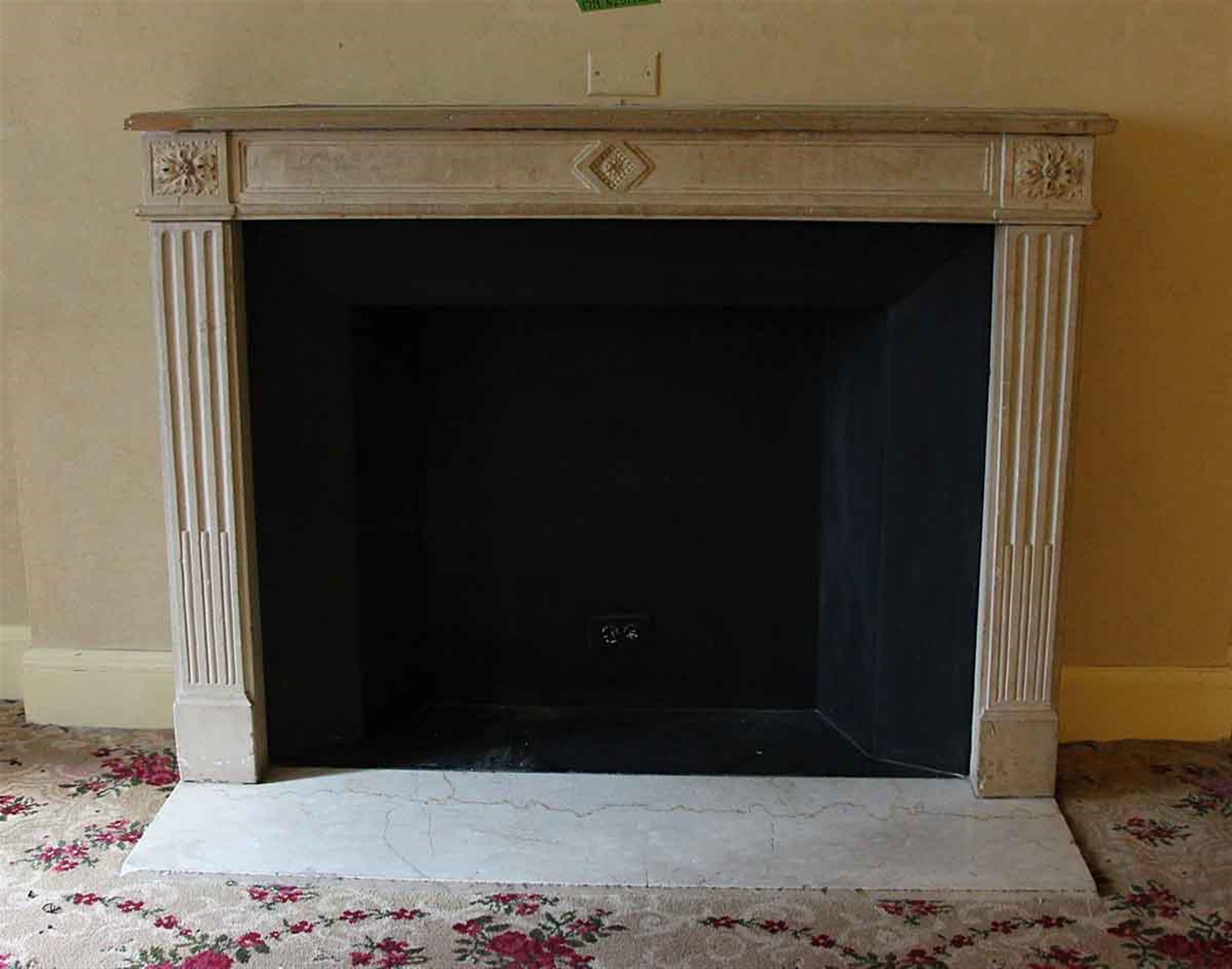 Louis XVI French Regency carved limestone mantel from 1890s France. This mantel was imported from France and installed in the NYC Waldorf Astoria Hotel on Park Avenue in New York City in 1931. There is minor chipping which appears somewhat evenly on