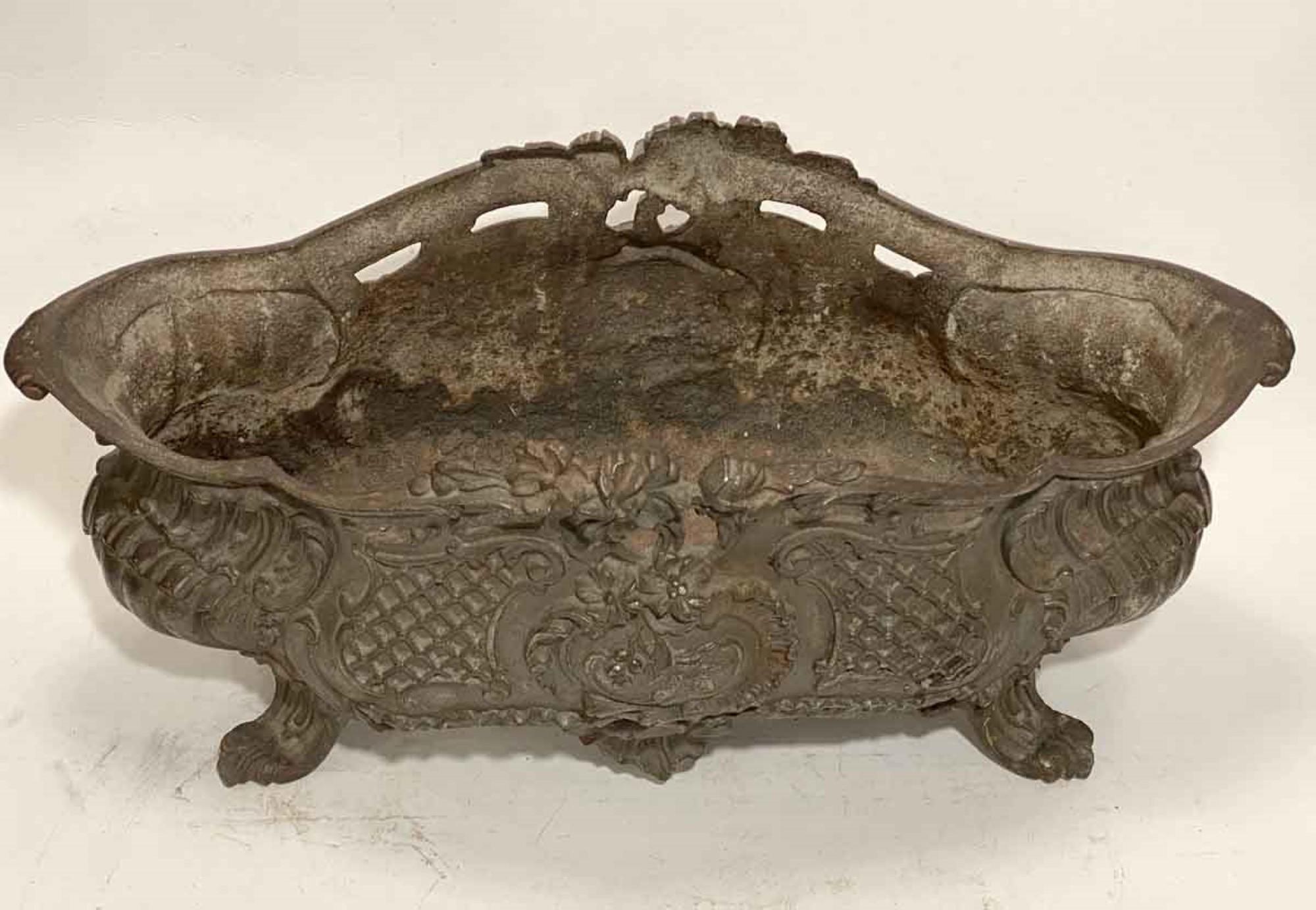 Antique finely cast 1890s French iron jardinières or planters with a wonderful original patina. Priced as a pair. Slightly dissimilar sizing. This can be seen at our 333 West 52nd St location in the Theater District West of Manhattan.