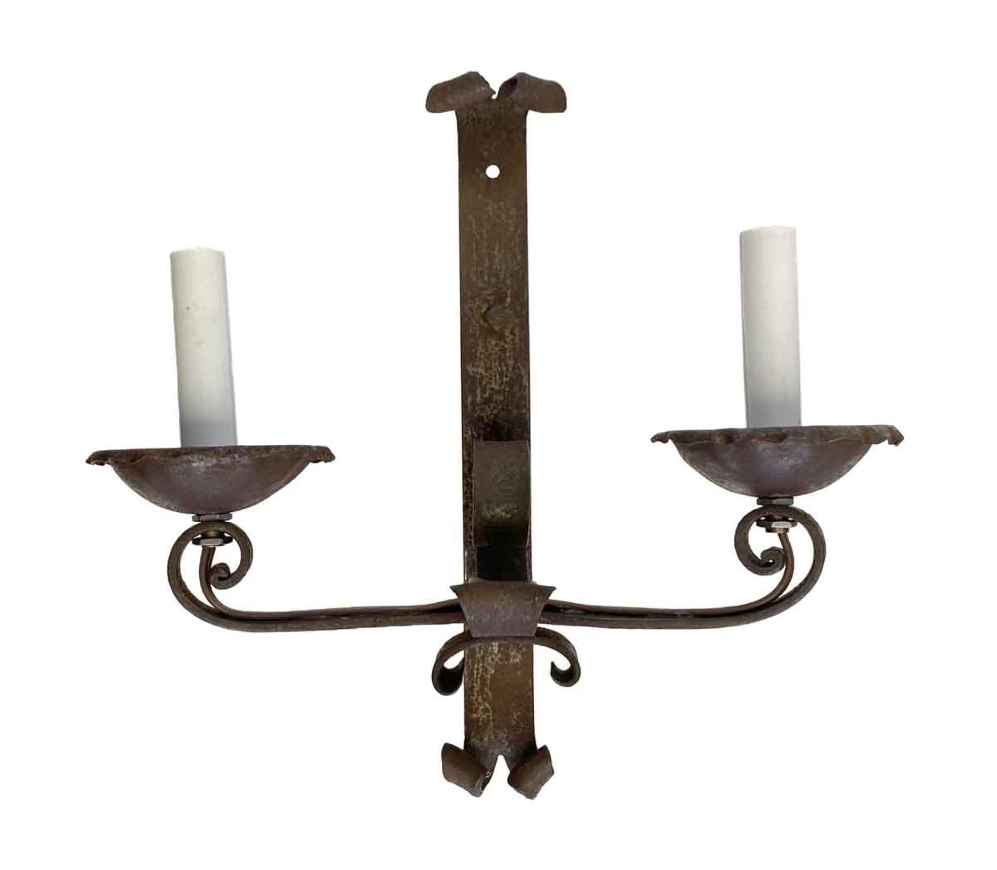 1890s hand hammered wrought iron sconces with scrollwork from France with a black rusted finish. Newly rewired.