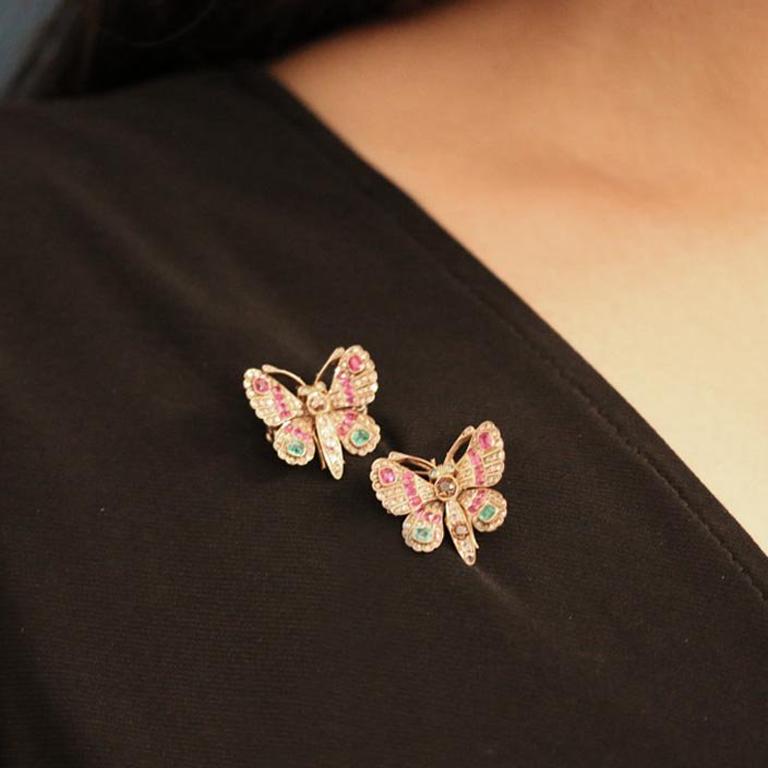 A pair of Victorian gem set butterfly brooches. A pair of brooches, set to the bodies with a cushion shape old mine natural unenhanced fancy colour pink diamond in an open back grain and rubover setting with a weight of 0.10 carats, additionally set