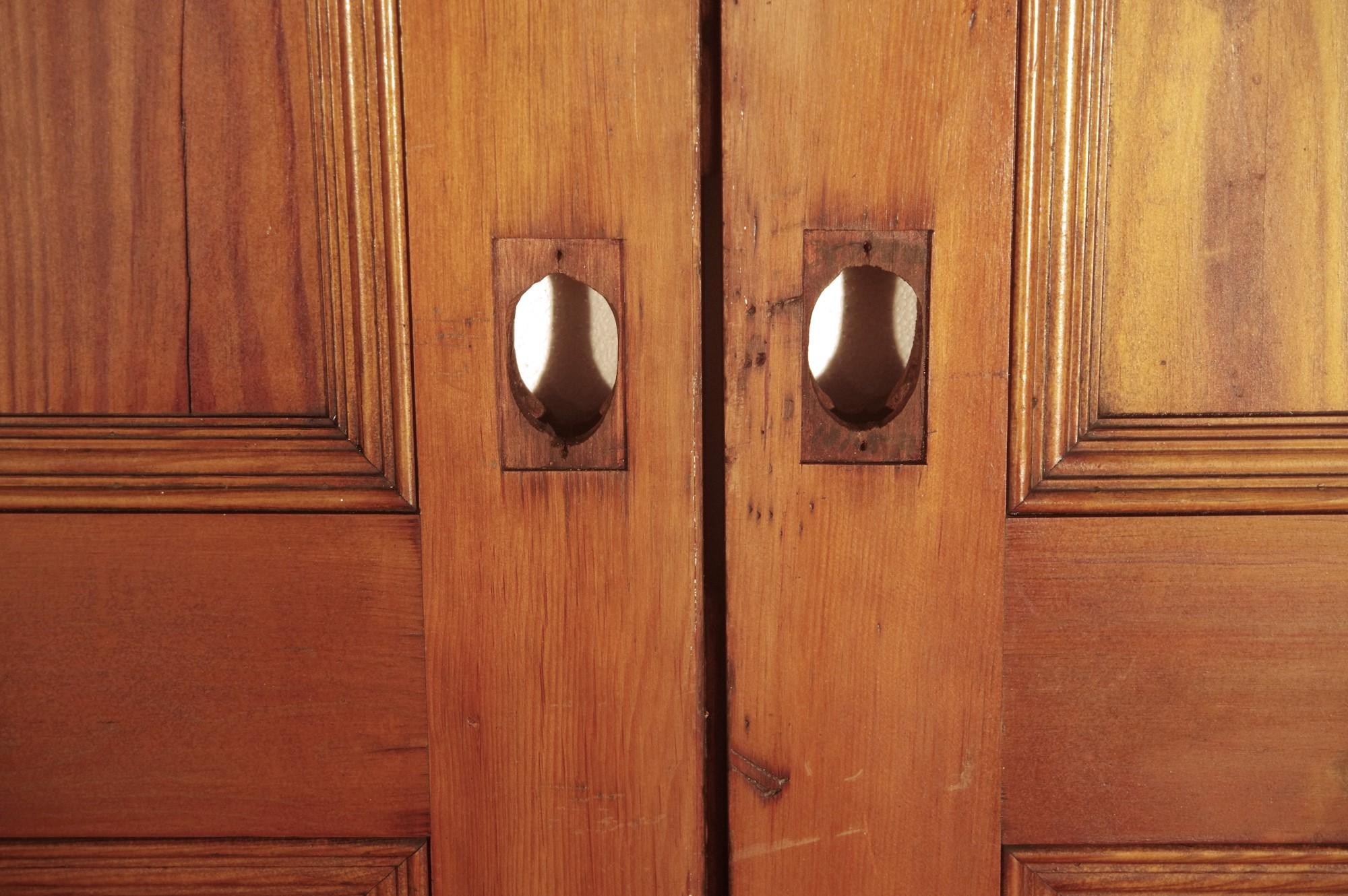 Dark stained pine pocket doors with five recessed panels measuring 101.5 x 72.5 from the late 1800s. Top hardware as shown in the pictures included. Priced as a double.