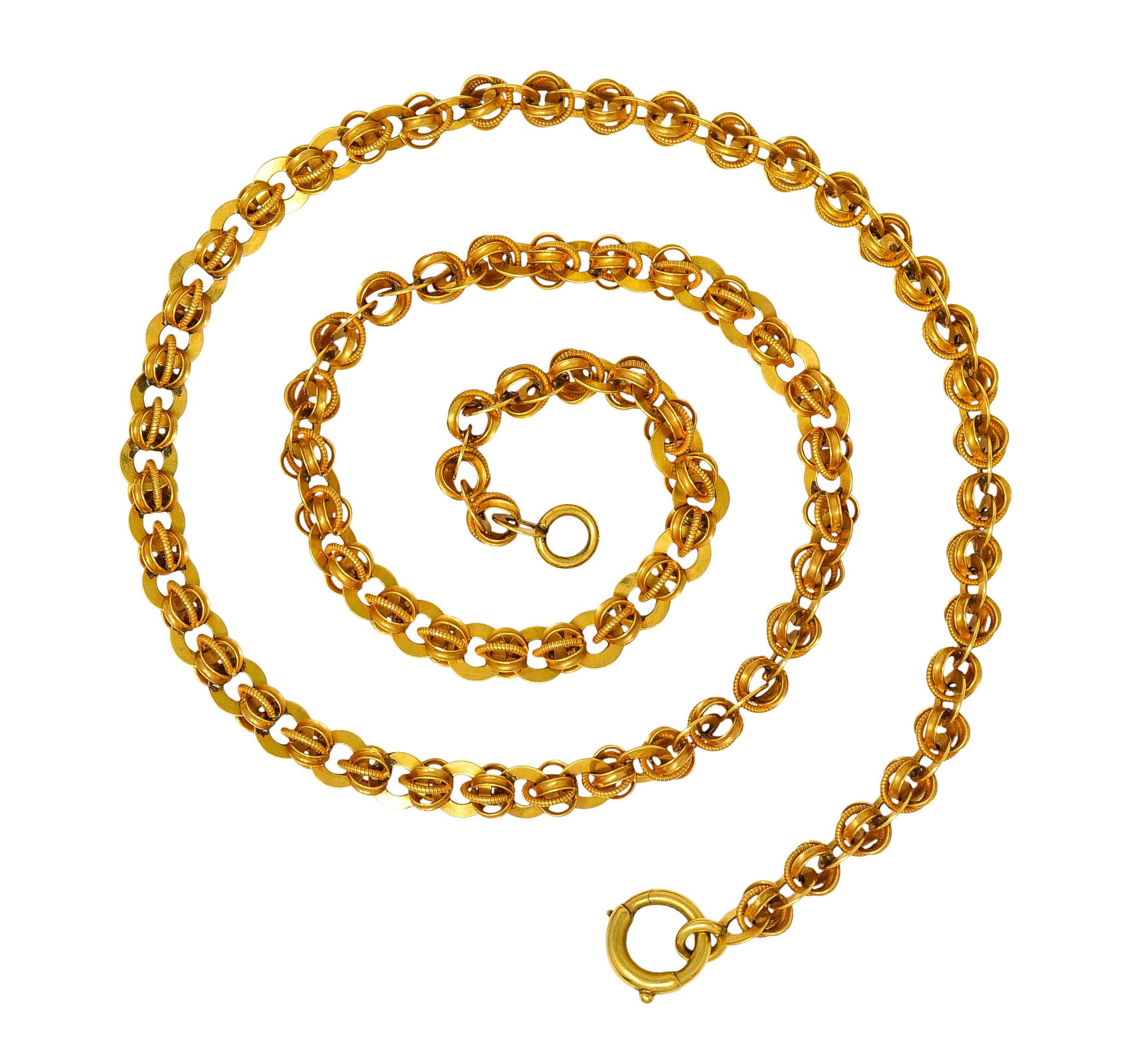 Chain necklace is comprised of triple segmented links with a finely ribbed texture

Alternating with circular spacer link disks

Tested as 14 karat gold

Circa: 1890s

Length: 19 inches

Width: 1/4 inches

Total weight: 21.8 grams

Effortless.