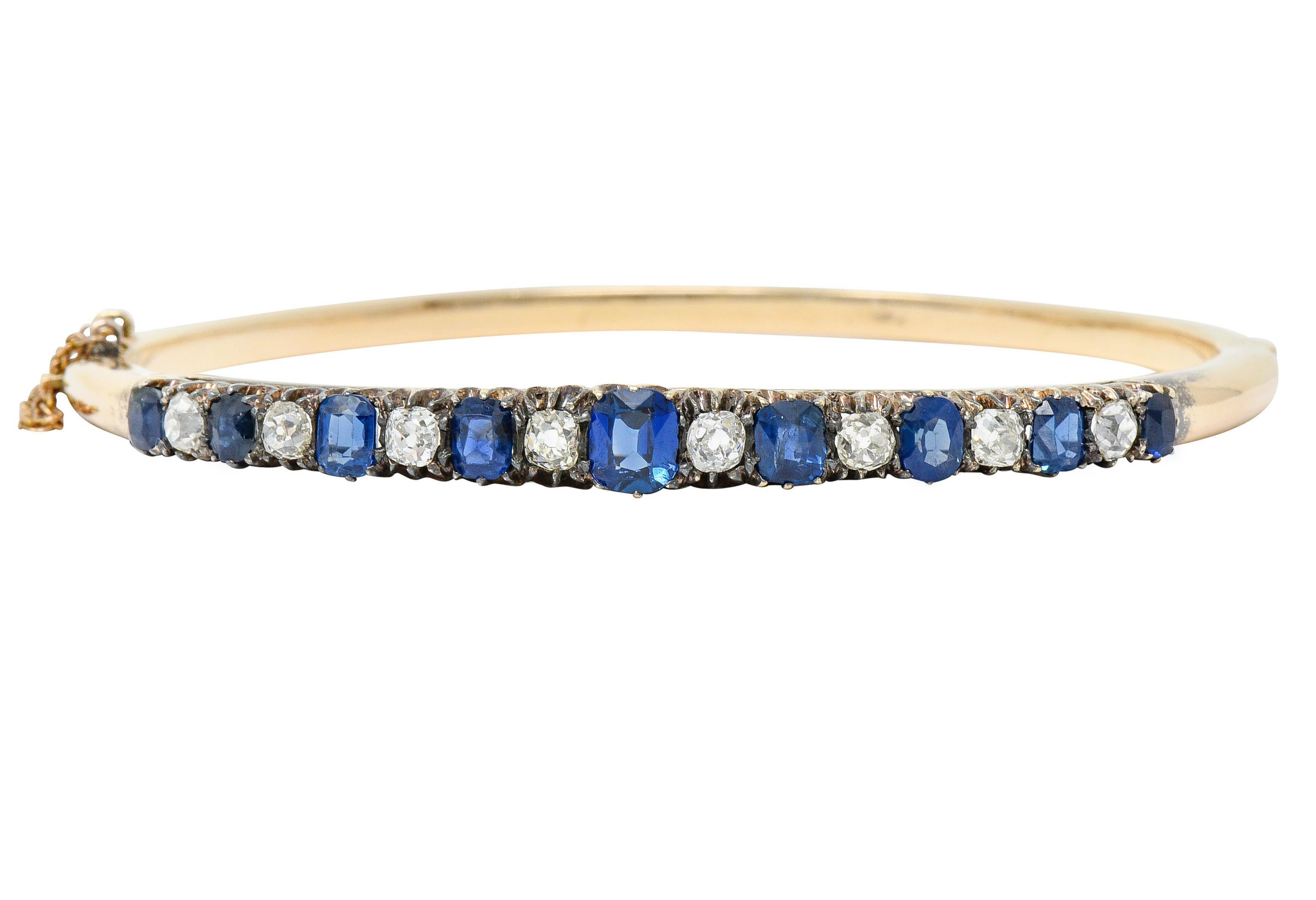 Hinged bangle bracelet claw set to front with diamonds and sapphires, alternating

Cushion cut sapphires are bright royal blue and well-matched while weighing approximately 2.10 carats

Old mine cut diamonds weigh in total approximately 1.04 carats