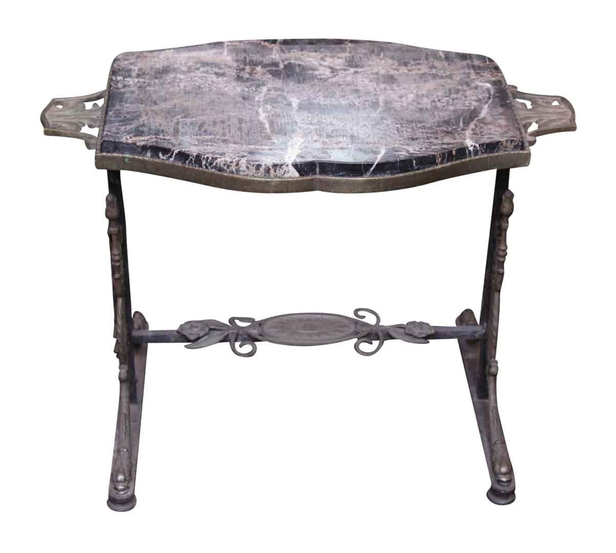 1890s Victorian handwrought bronze table is matched with a marble top. This can be seen at our 333 West 52nd St location in the Theater District West of Manhattan.