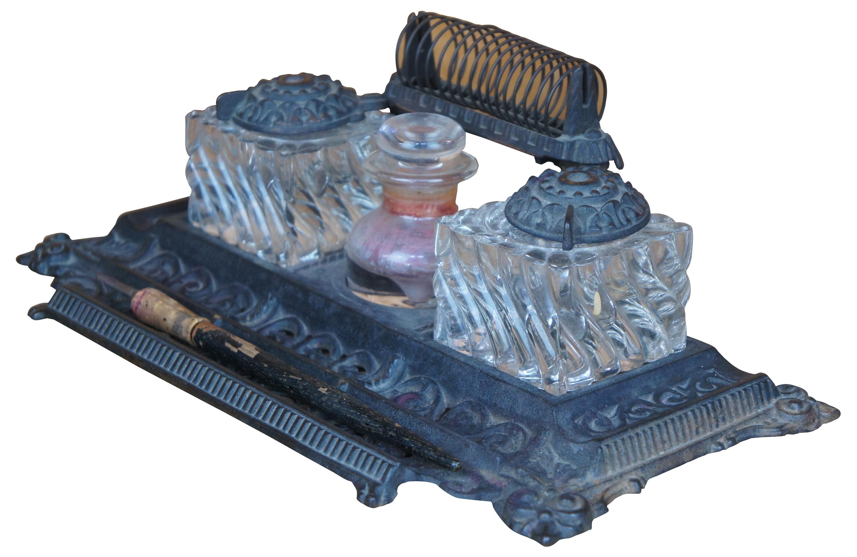 Antique 1892 cast iron desk set / ink caddy featuring letter holder, pen tray and two glass inkwells made by Tatum's.
 
